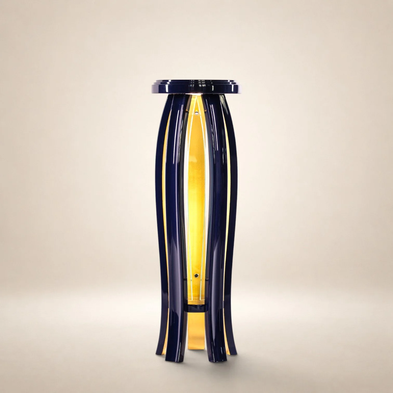A modern black and yellow illuminated sculpture with elongated curved black glass arms and yellow accents, standing vertically against a plain off-white background.