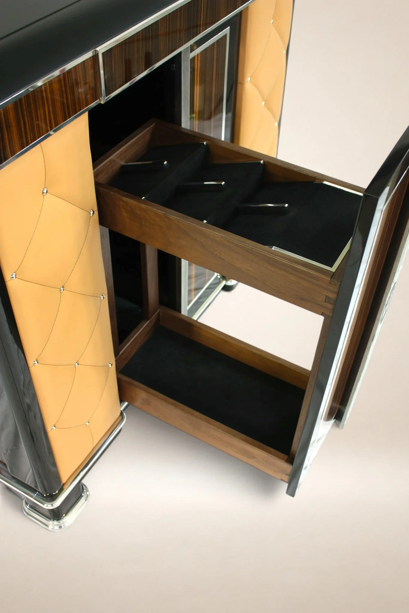 Decorative bar cart with a black, brown, and yellow design, an open drawer, and a black interior compartment.