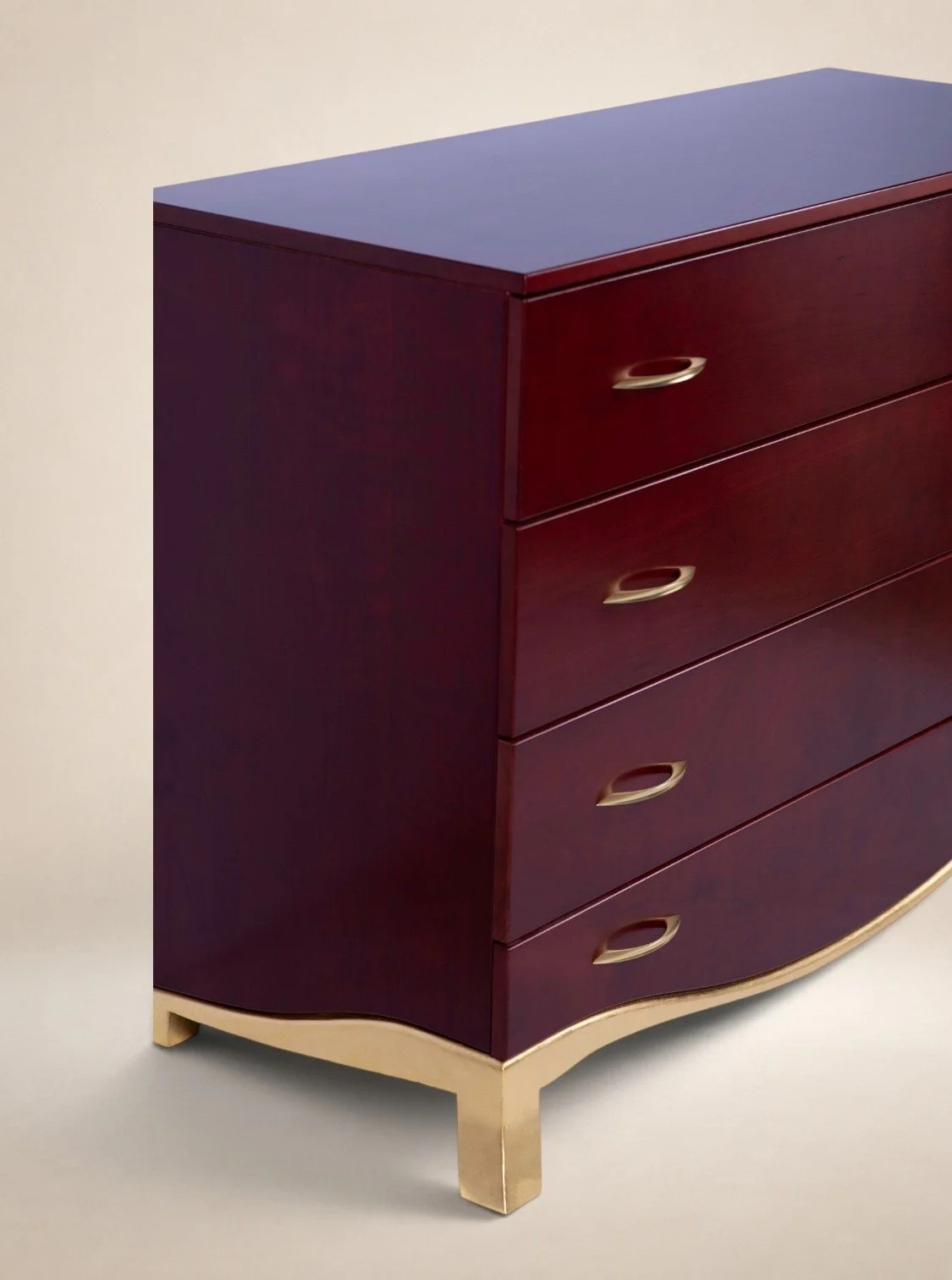 A red wooden dresser with five drawers and gold handles, standing on curved beige legs.