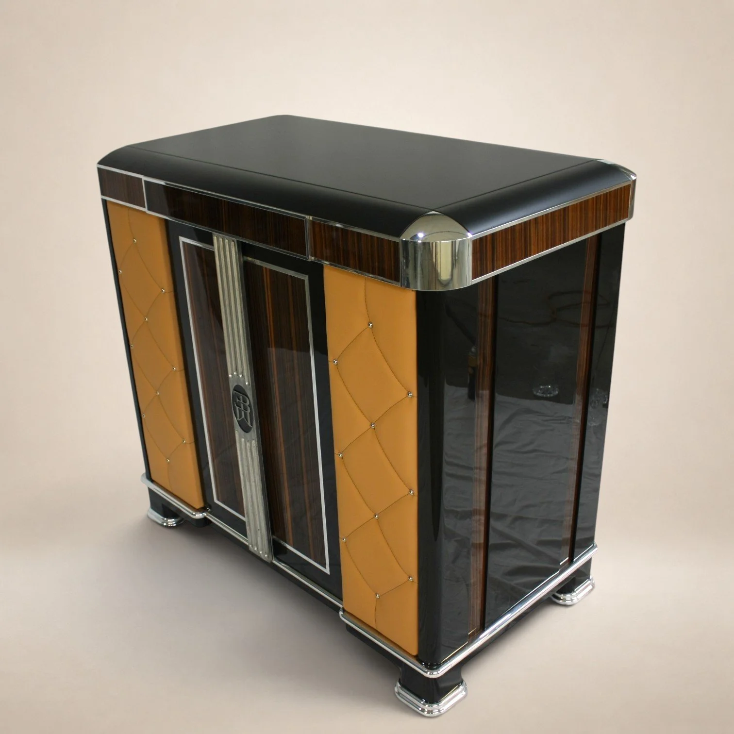 A vintage wooden and leather jewelry cabinet with metal accents, showing ornate design, drawers, and doors for storage.