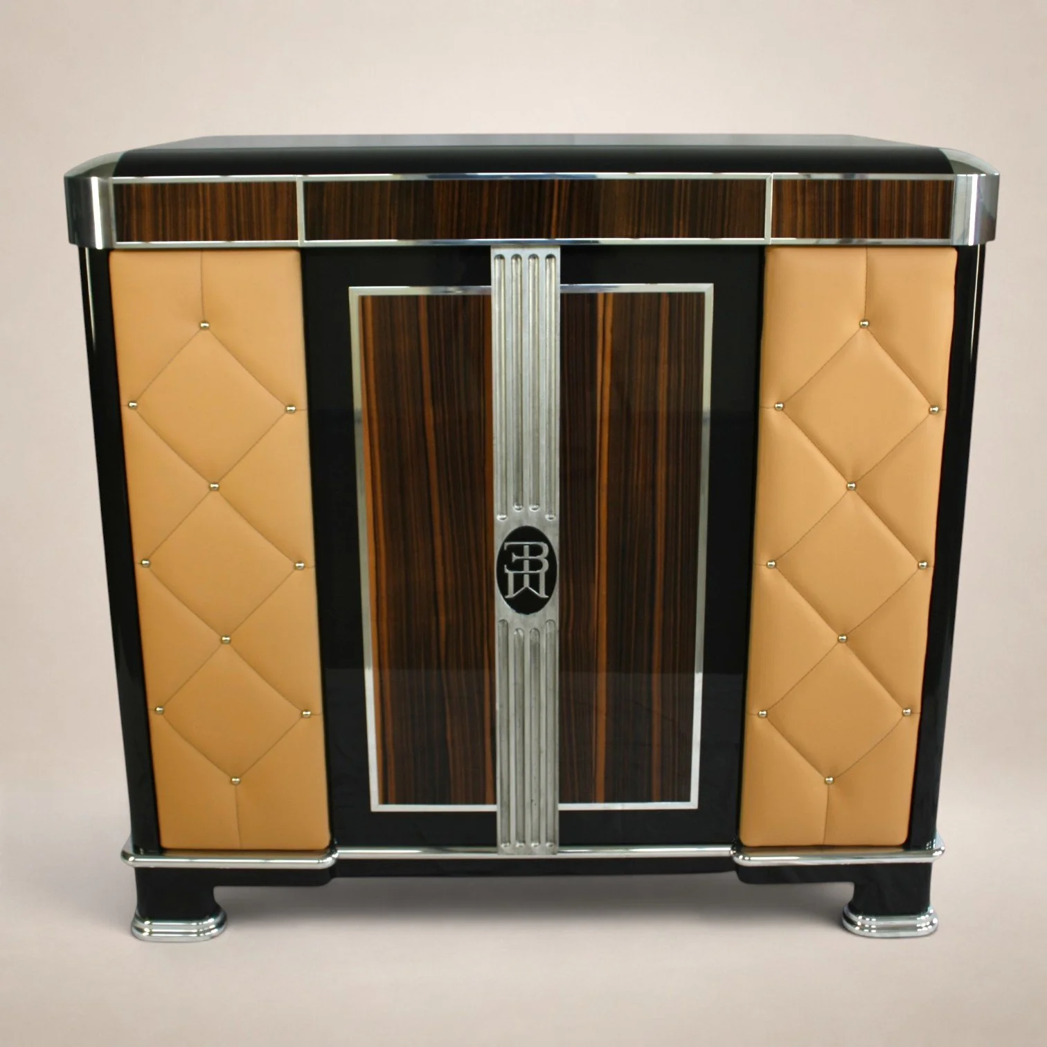 A vintage Art Deco style radio cabinet with wood paneling, black accents, and metal trim, featuring a central metal decorative element with the initials 'HR'
