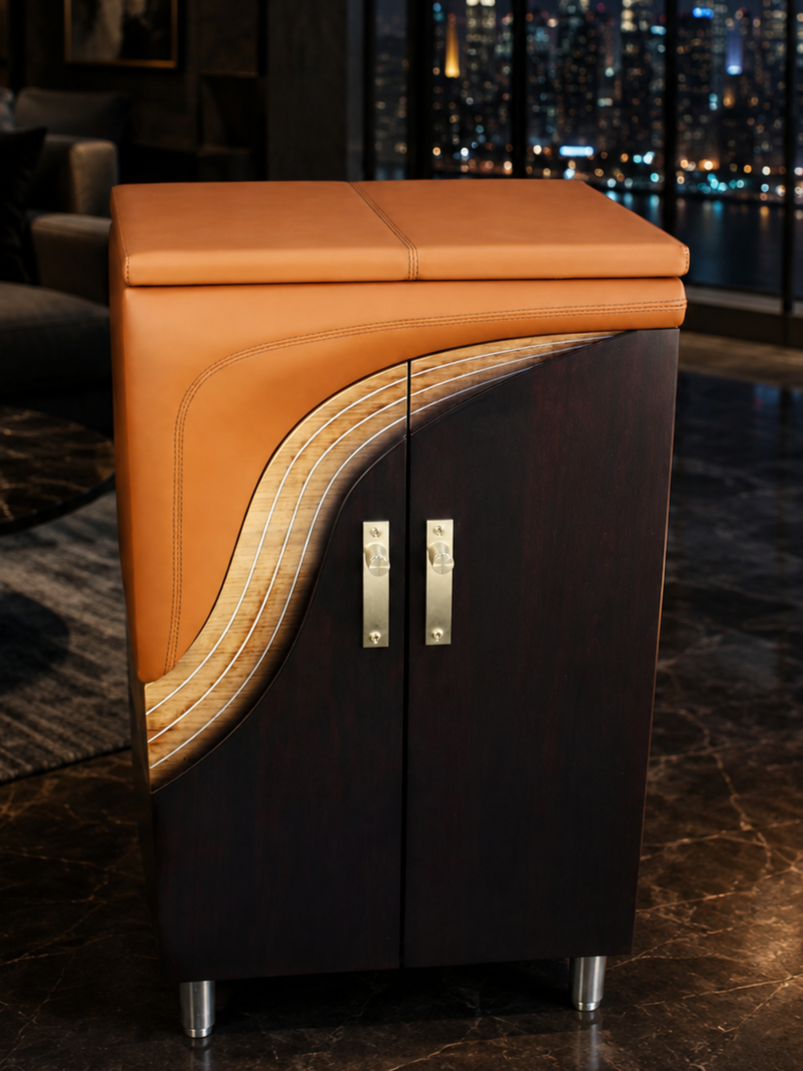 A wooden cabinet with a curved design, topped with a brown leather cushion, in a modern room with a city skyline view at night. Custom furniture