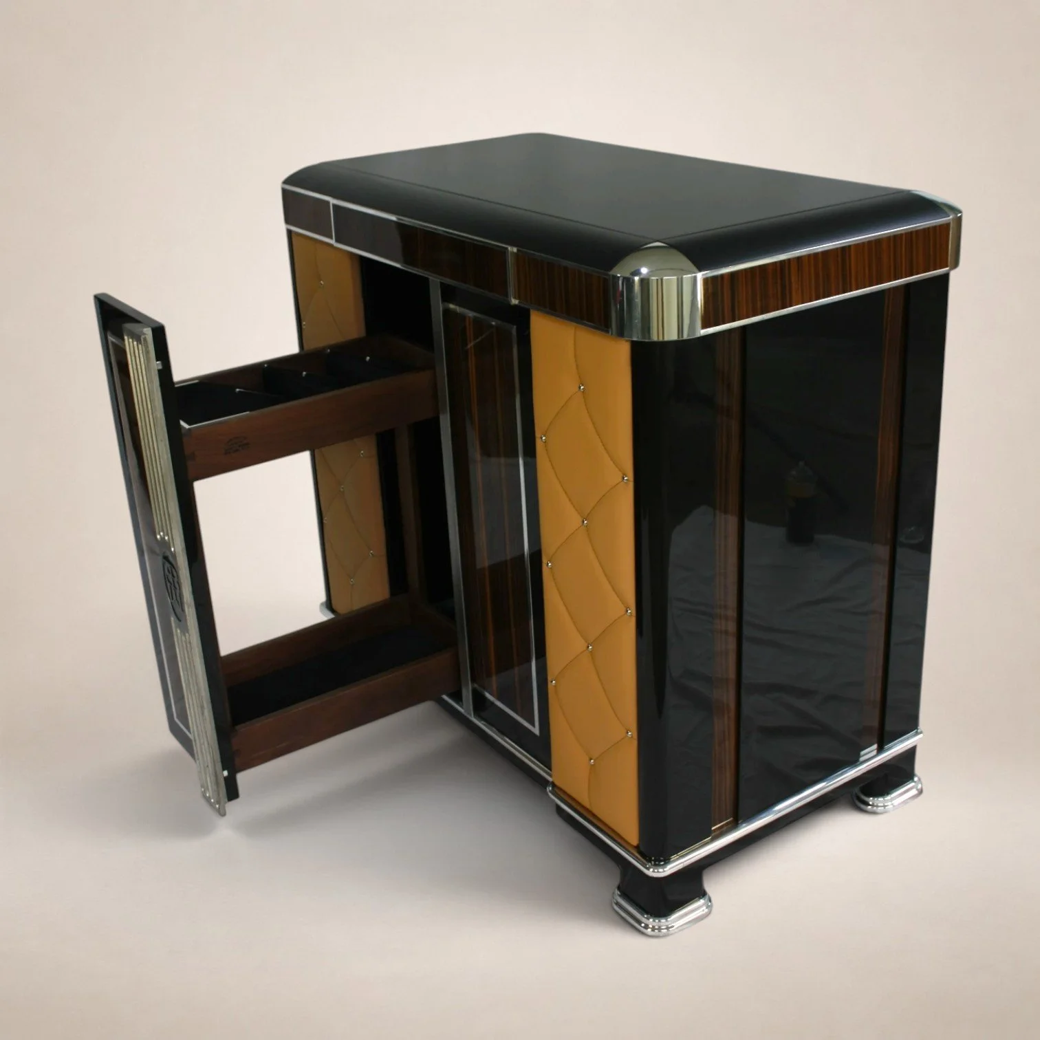A vintage modern bar cart with decorative wood and black accents, with one drawer partially pulled out, on a plain light-colored background.