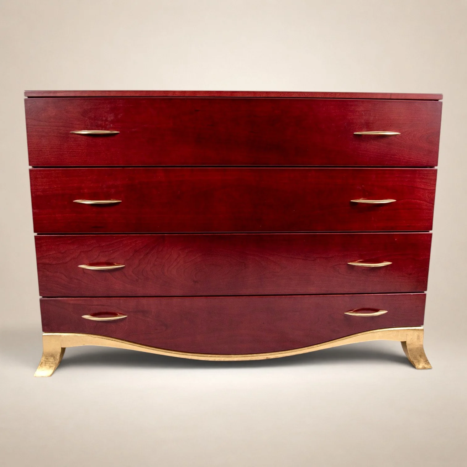 A wooden dresser with five drawers, gold handles, and curved gold legs.
