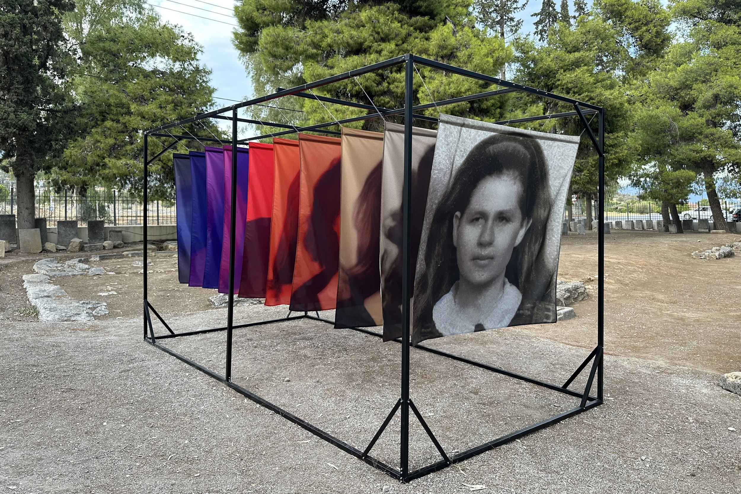 Soft Errors installation of ten semi-transparent portrait prints showing an anonymous woman's image transformed through recursive AI generation.