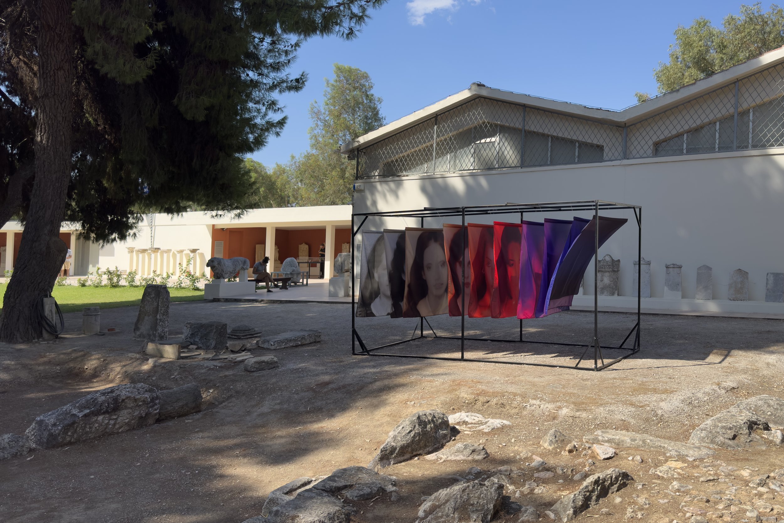 Side view of the Soft Errors fabric installation, where overlapping portraits trace the gradual deterioration of human and artificial memory.
