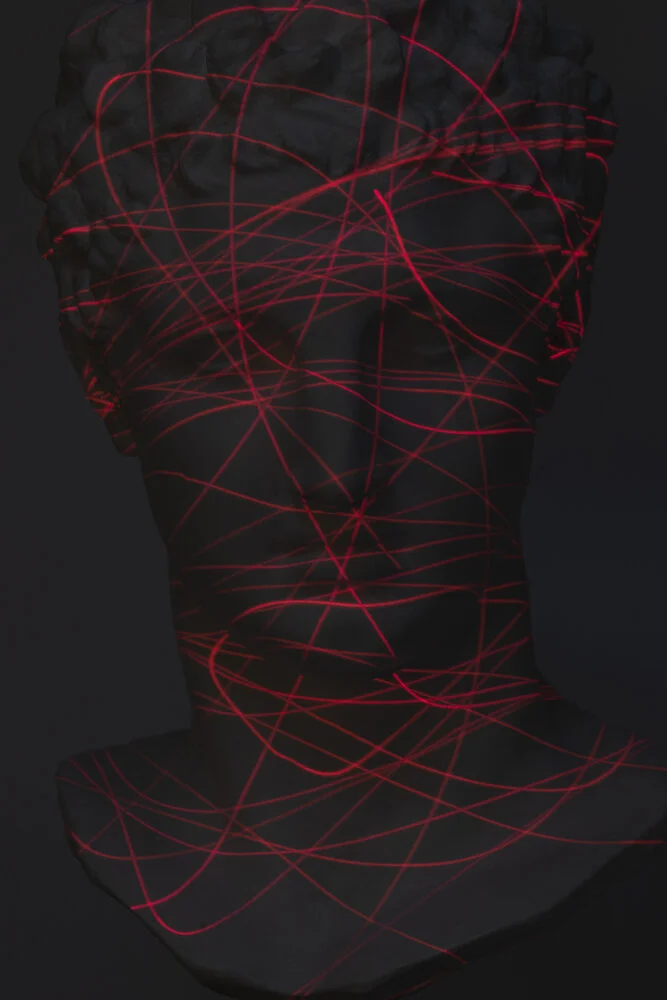 Blind Folded from Image Eaters: a classical bust covered in tangled red light trails, suggesting visual overstimulation and blindness within digital culture.