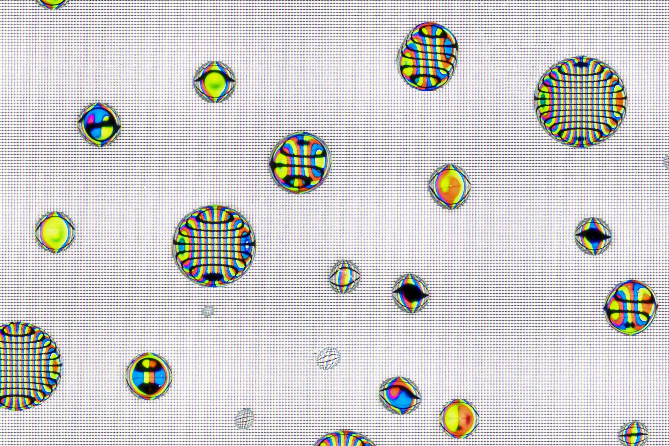 Macro detail from Tears, Spit & Cum, showing translucent bodily-fluid droplets magnifying and deforming the screen’s red, green and blue pixel structure.