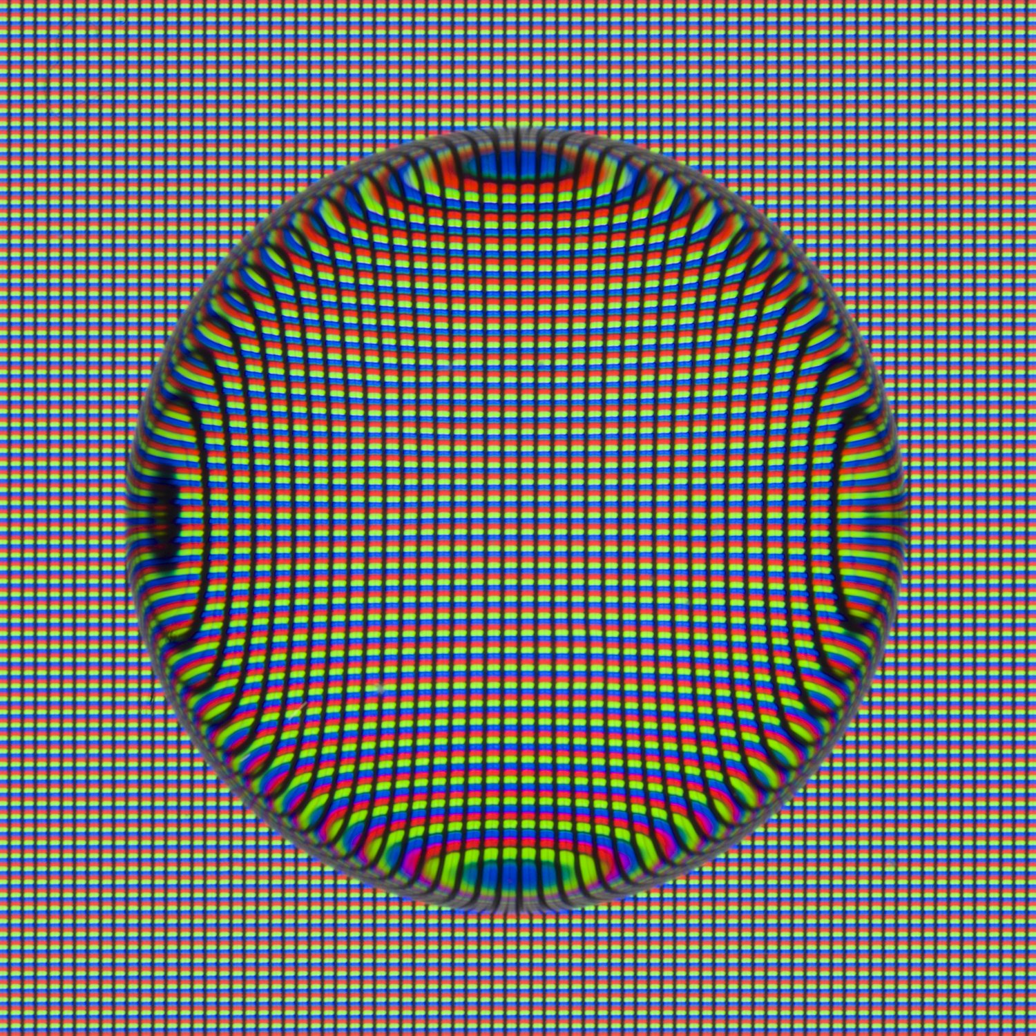 Close-up detail from Tears, Spit & Cum, where an organic droplet acts as a lens over a digital display, revealing distorted pixels and color patterns.