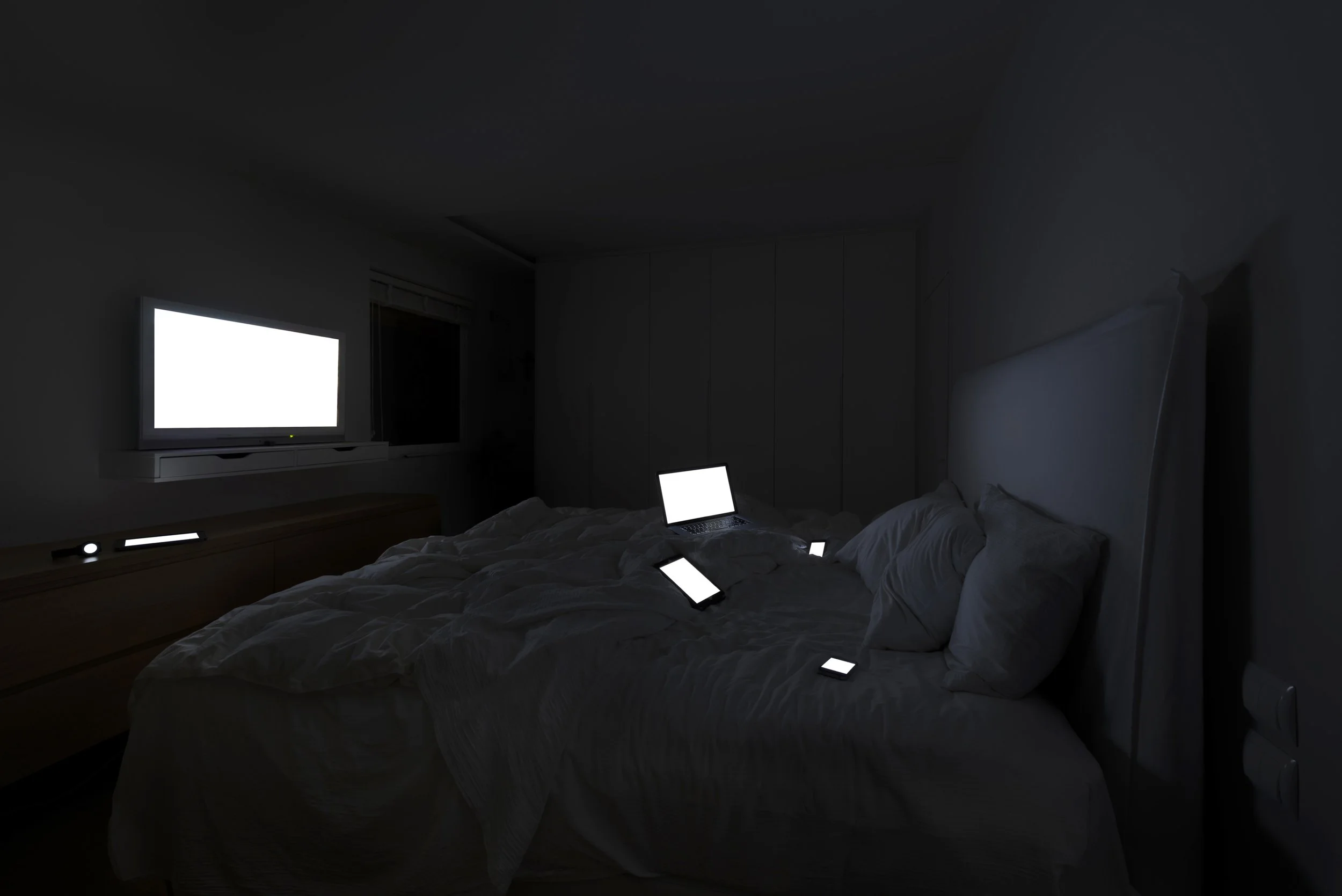 Sunday Afternoon from Family Portraits by Maria Mavropoulou, showing connected devices staged as family members in an everyday domestic scene, exploring screen-mediated companionship and isolation.