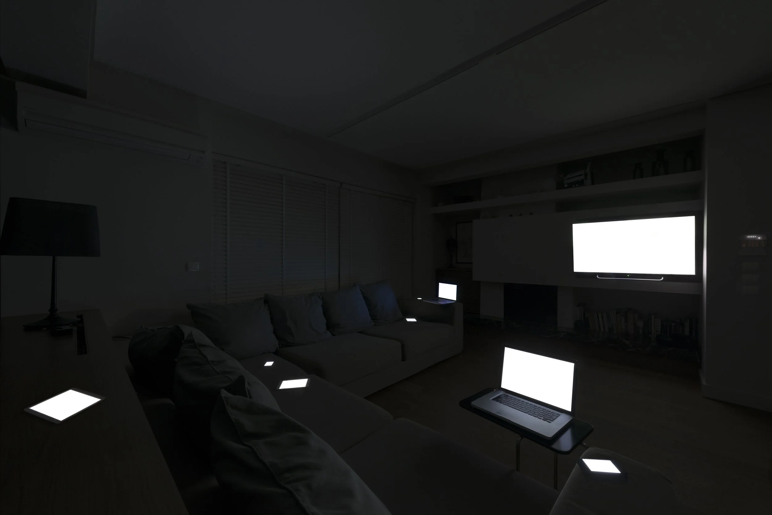 Evening with Friends from Family Portraits by Maria Mavropoulou, showing glowing screens gathered like companions and examining digital connection, social life and technologically mediated intimacy.