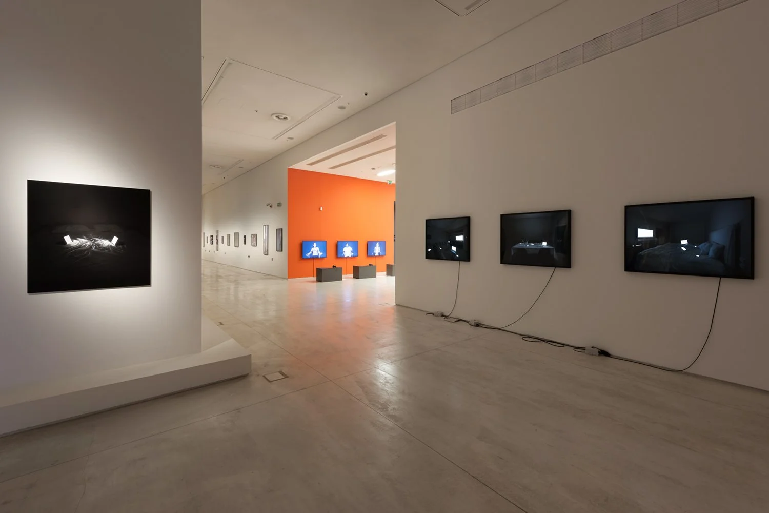Installation view of Family Portraits in Modern Love at EMST, Athens, 2023, showing staged photographs of connected devices presented as family members and intimate companions.