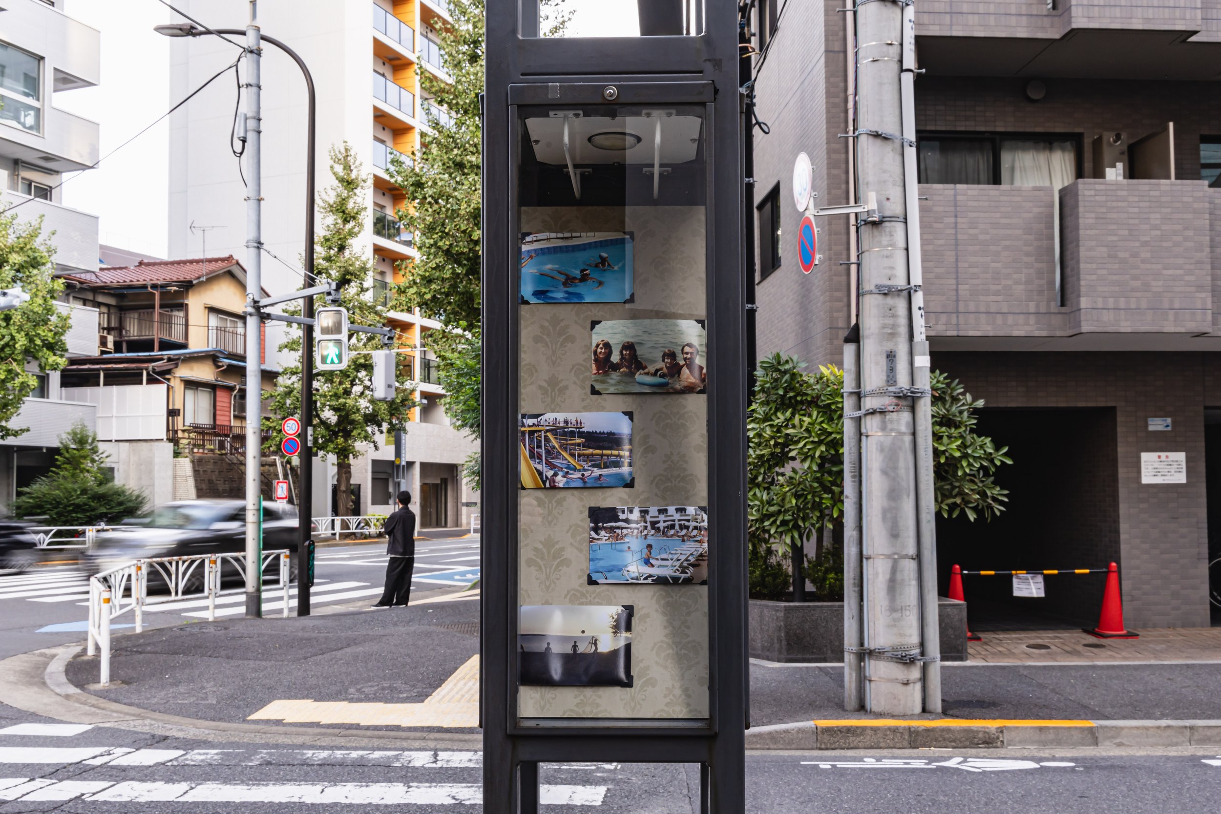 Public installation detail of Imagined Images on Shibuya street posts for European Month of Photography Tokyo, linking migration and synthetic family memory.