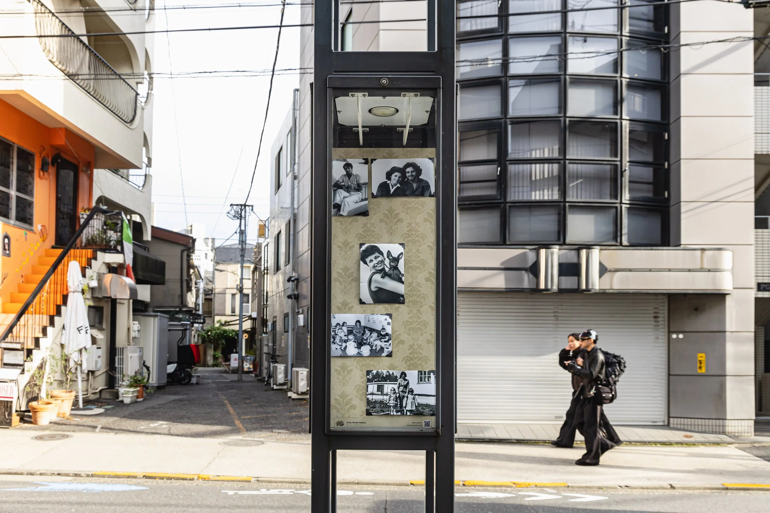 Imagined Images installed across street posts in Shibuya for European Month of Photography Tokyo, bringing an AI-reconstructed family album into public space.