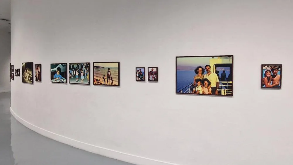 Installation detail of Imagined Images at BACC Bangkok in 2024, showing DALL·E-generated family scenes based on inherited stories.