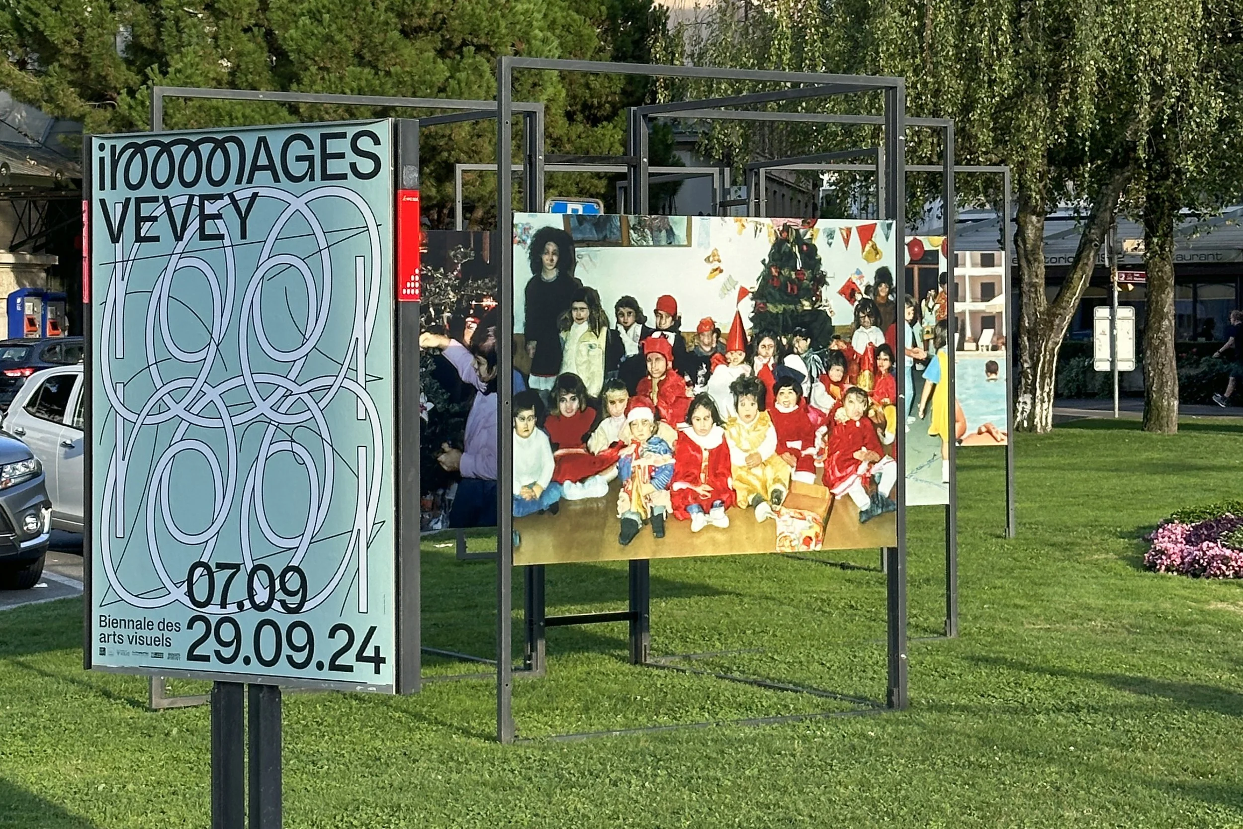 Detail of the open-air Imagined Images installation at Images Vevey 2024, presenting reconstructed family photographs on freestanding panels.