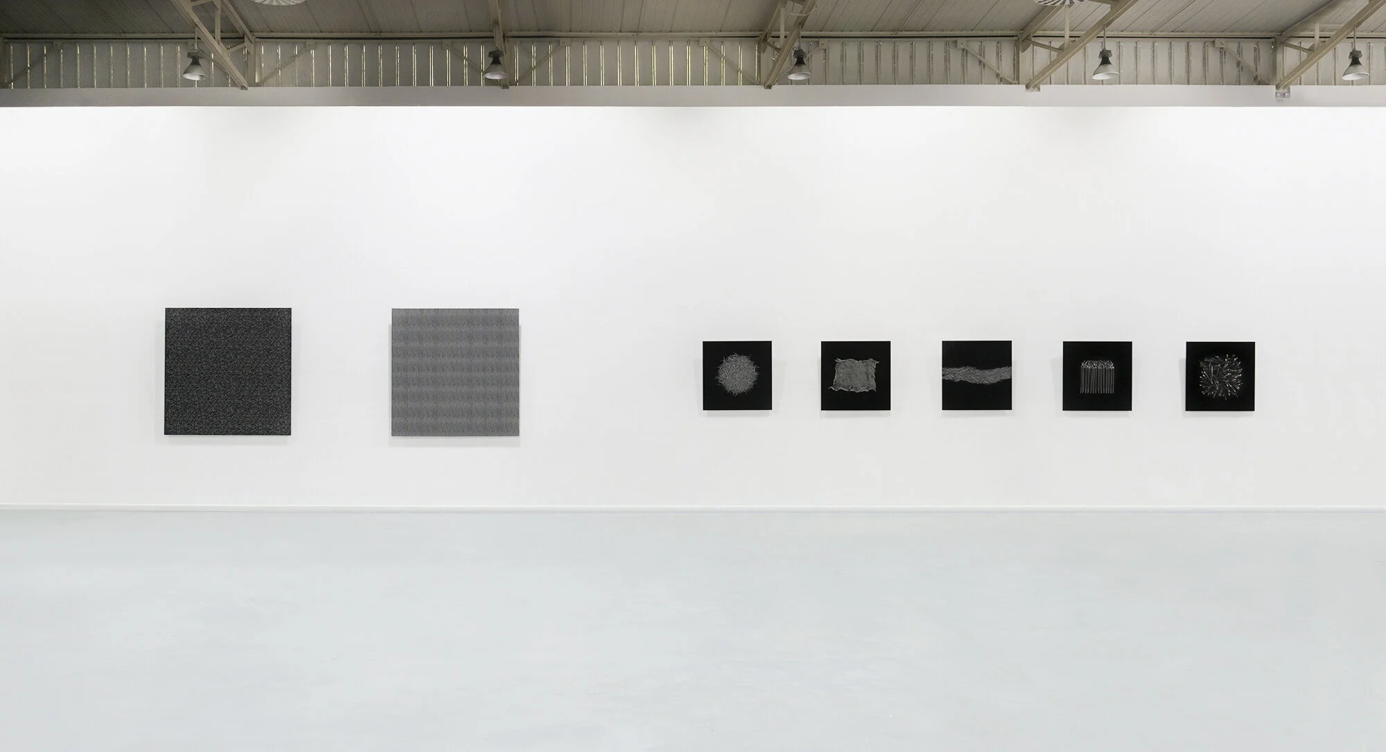 Installation view of Geometry of Chaos at the Athens School of Fine Arts, presenting repeated nails as interconnected microcosmic and macrocosmic systems.