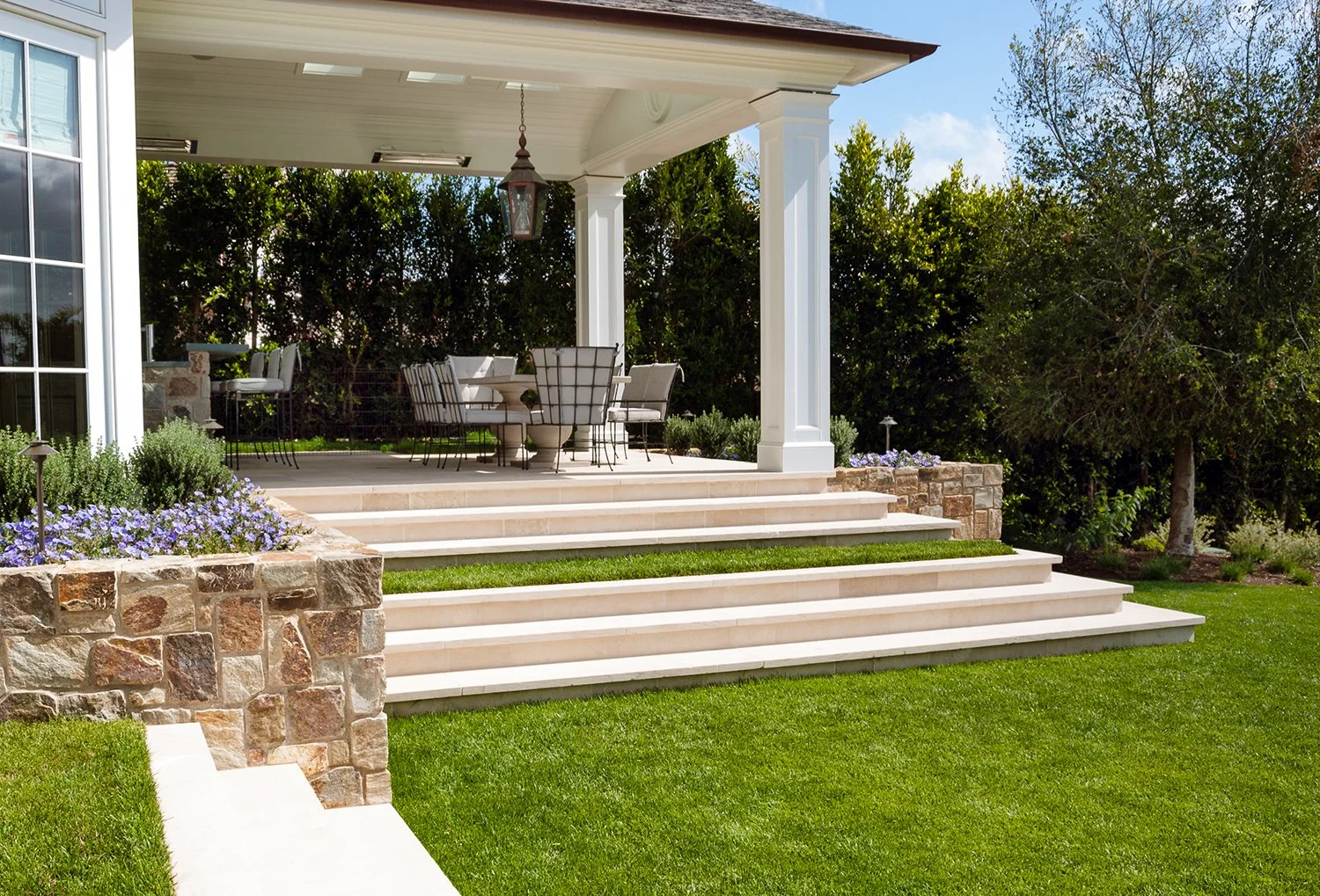 Dining/ entertainment terrace with limestone paving is tucked into the garden and surrounded by specimen trees. 