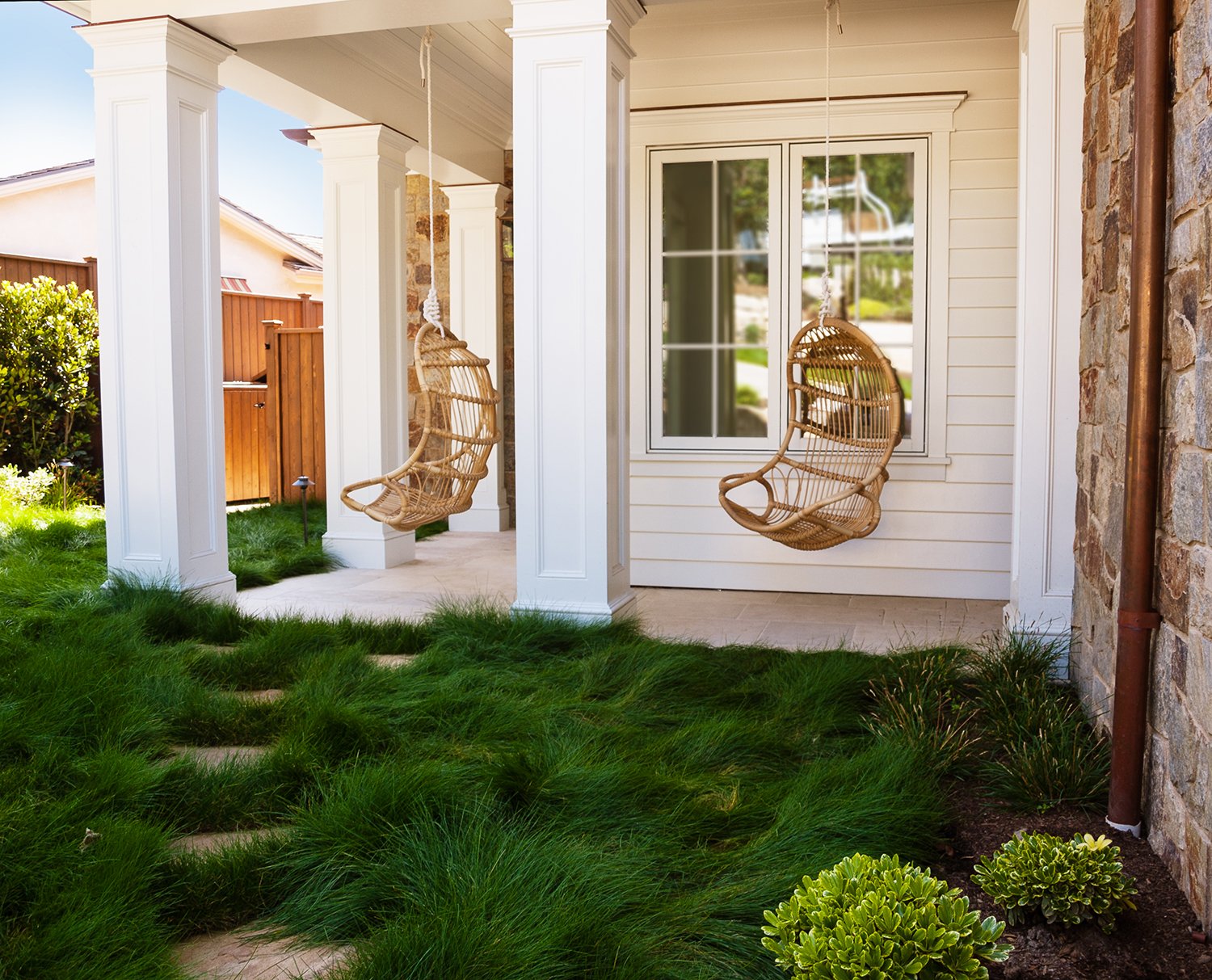 Shady porch swings amid soft long grasses.