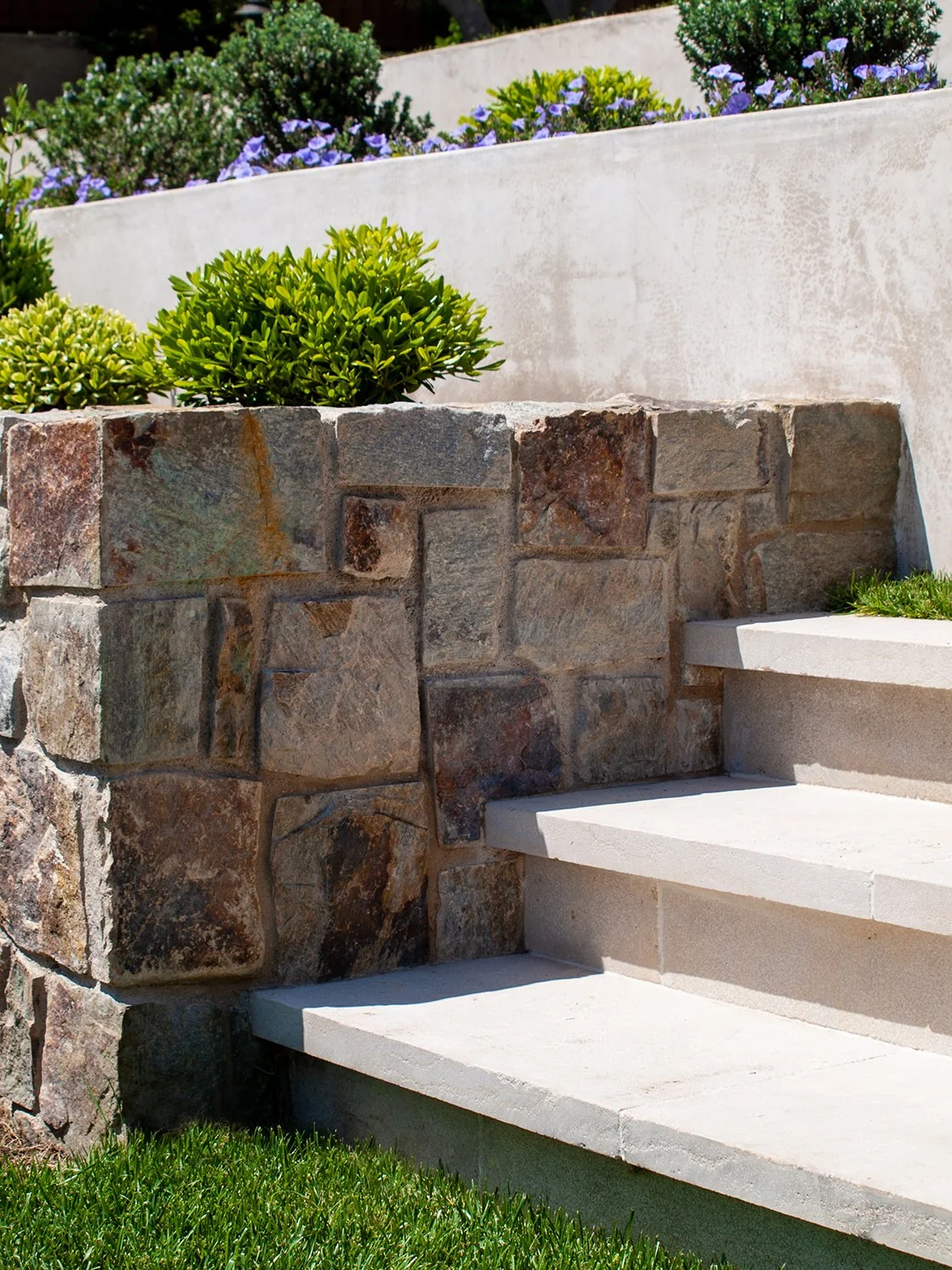 Steps with limestone treads; garden walls are stone.