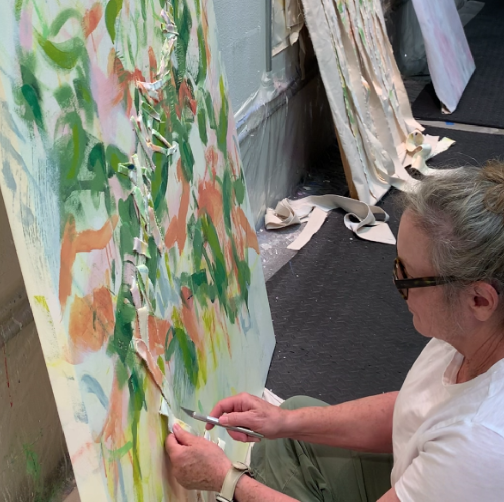 cutting painting to begin weaving into it