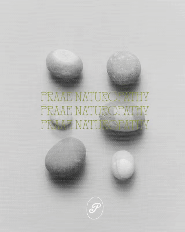 Multiple stones arranged on a surface with the words "PRAAE NATUROPATHY" written repeatedly in green text in the middle of the image.