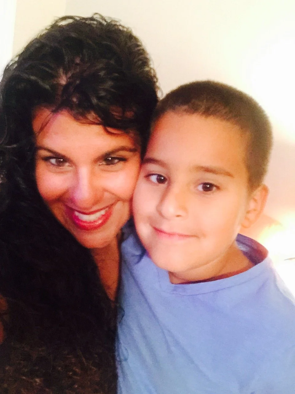 Julie and kid nick cheek to cheek hug.JPG