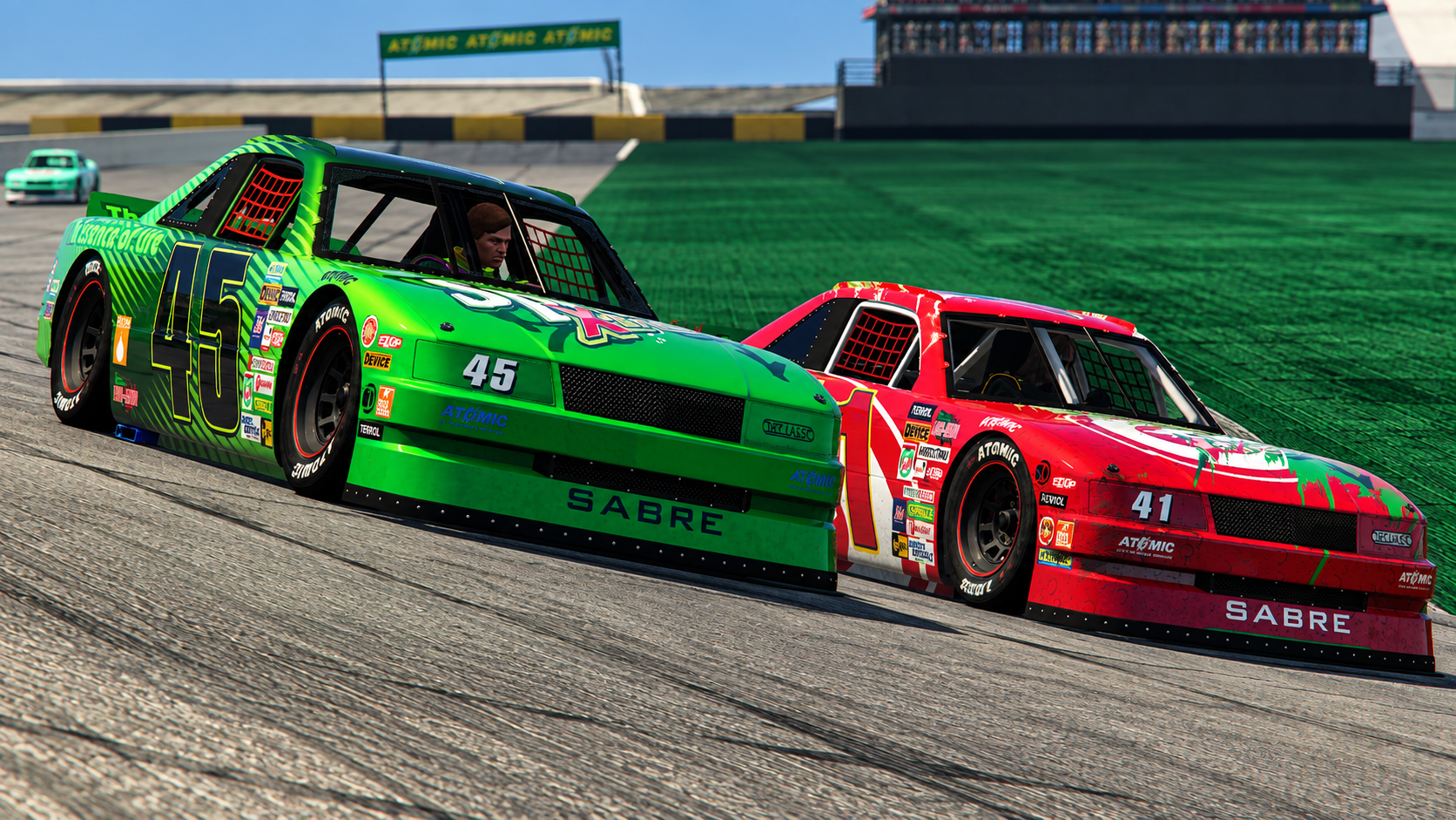 Two race cars on a racetrack, one green number 45 and one red number 41, both with various sponsor decals, racing closely together on a curve with green grass and a grandstand in the background.
