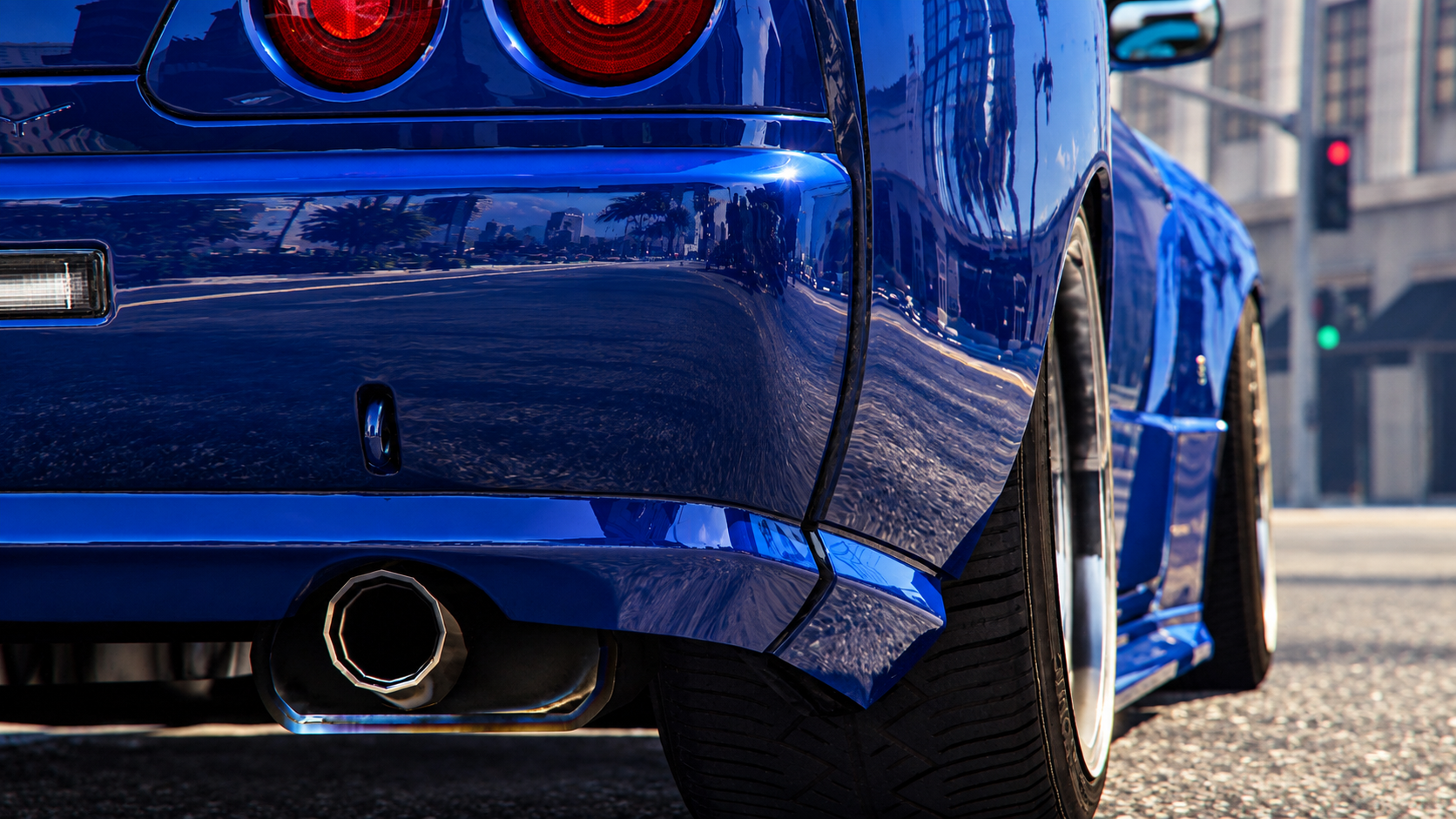Close-up of the rear end of a shiny blue sports car on a city street, reflecting palm trees and buildings, with a visible rear wheel and exhaust pipe.