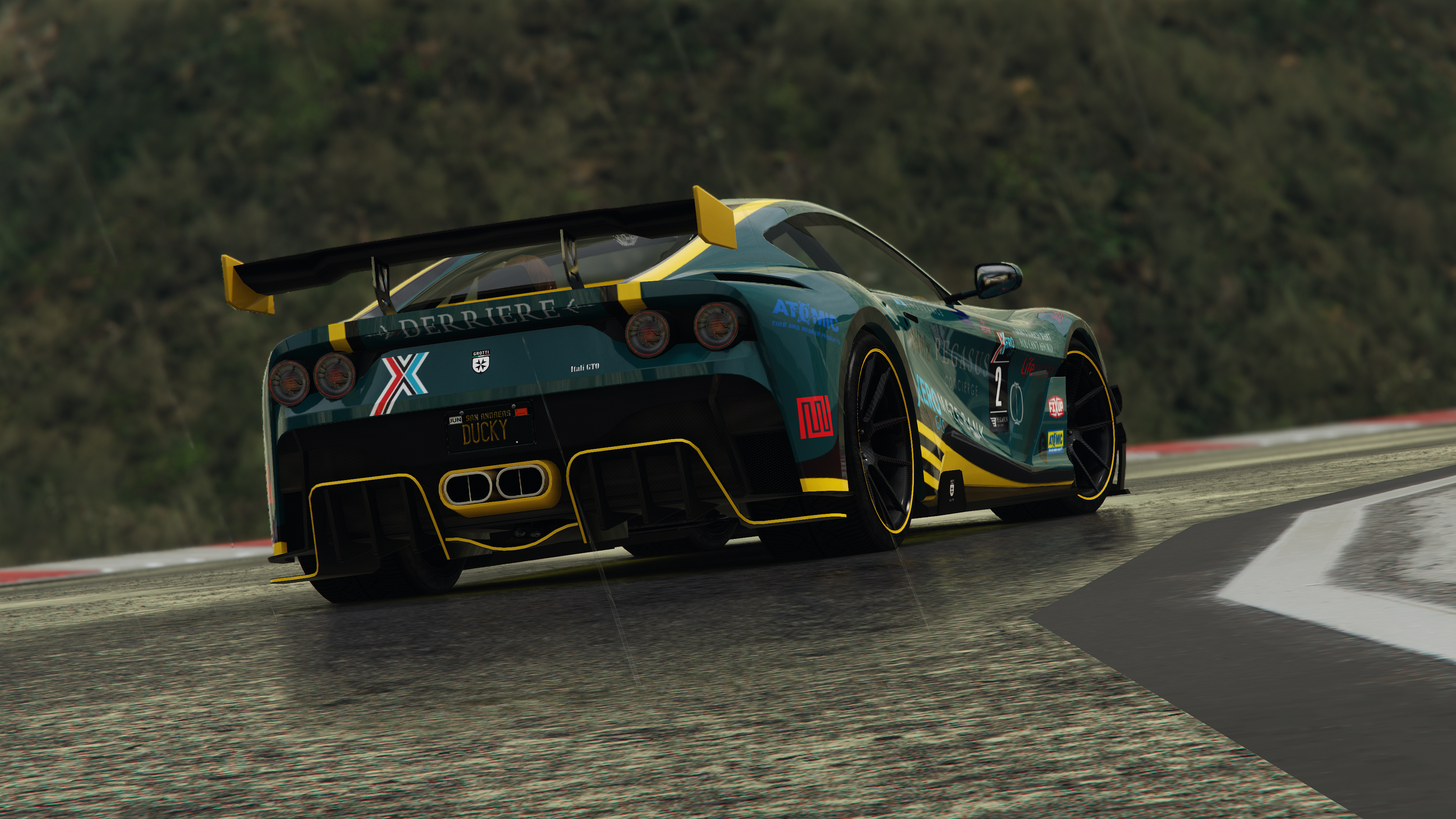 A race car on a track with a mountainous background, featuring a prominent yellow rear wing, vivid blue and black livery with sponsor logos, and detailed aerodynamic features.
