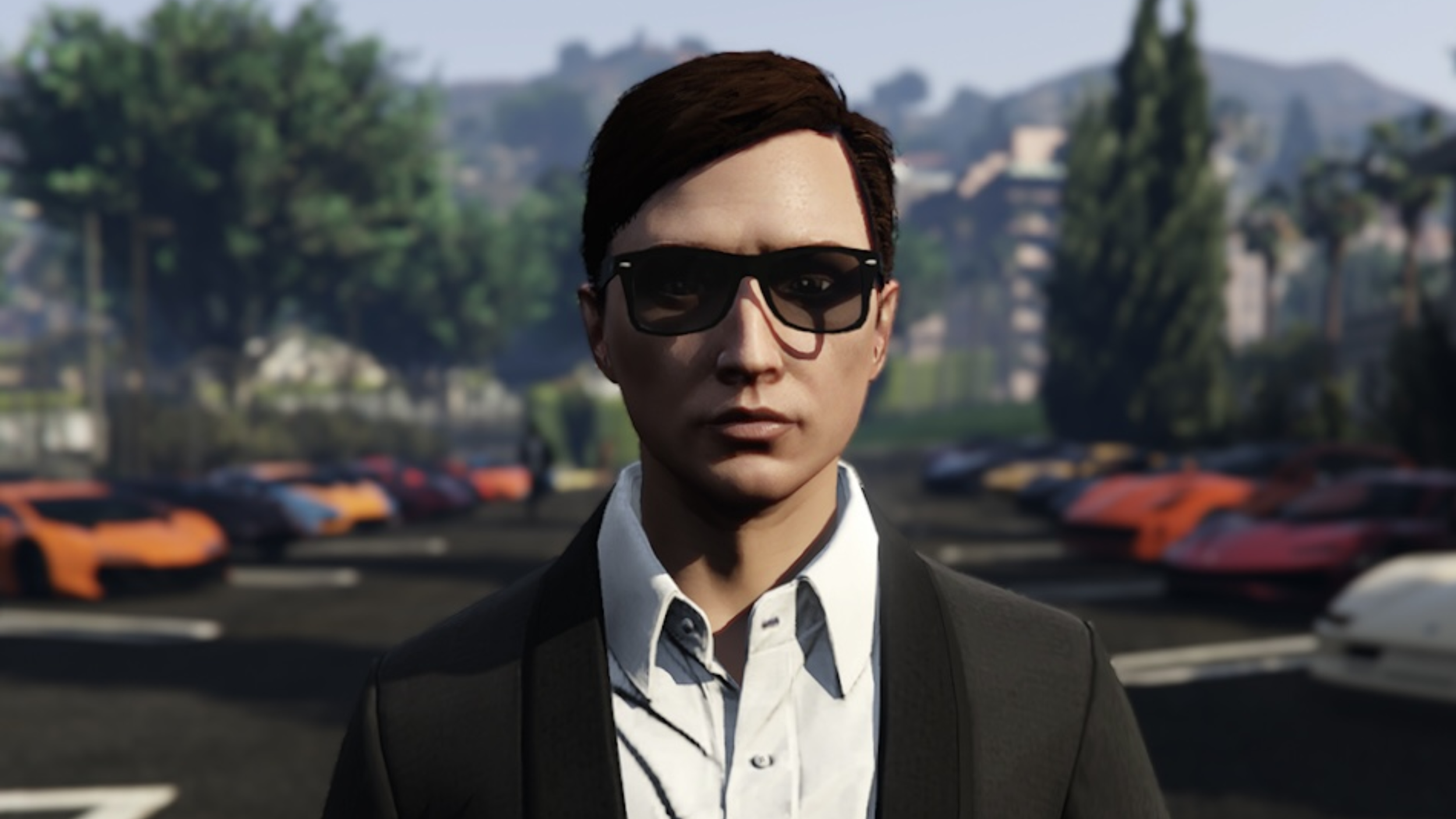 A virtual avatar of a woman with short dark hair wearing large sunglasses, a black blazer, and a white shirt, standing in front of a background with colorful cars parked in a lot and blurred hills and trees.