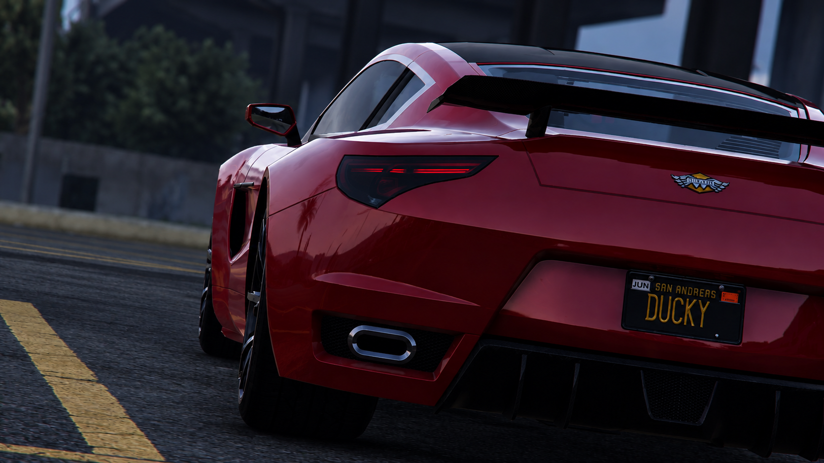 Red sports car driving on the street with a custom license plate reading "DUCKY" and a rear spoiler.