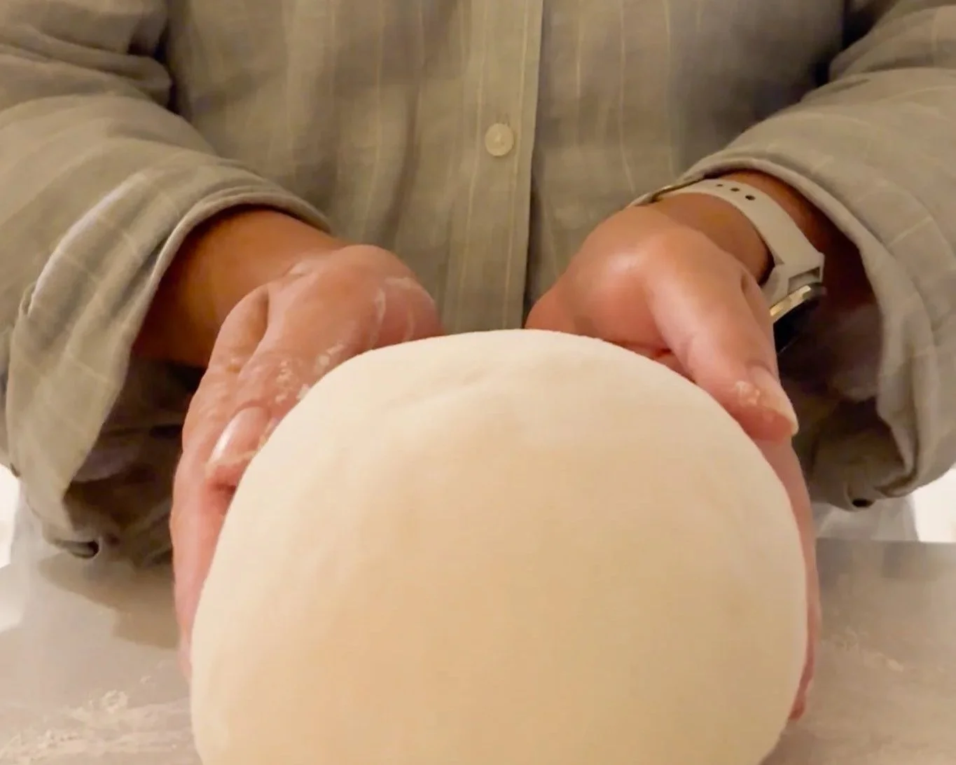 Hannah rolling out sourdough bread, folding dough