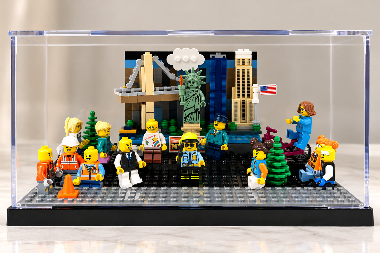LEGO minifigures gathered in front of a cityscape diorama with the Statue of Liberty, Empire State Building, and a crane, representing New York City, with some figures holding signs and accessories.