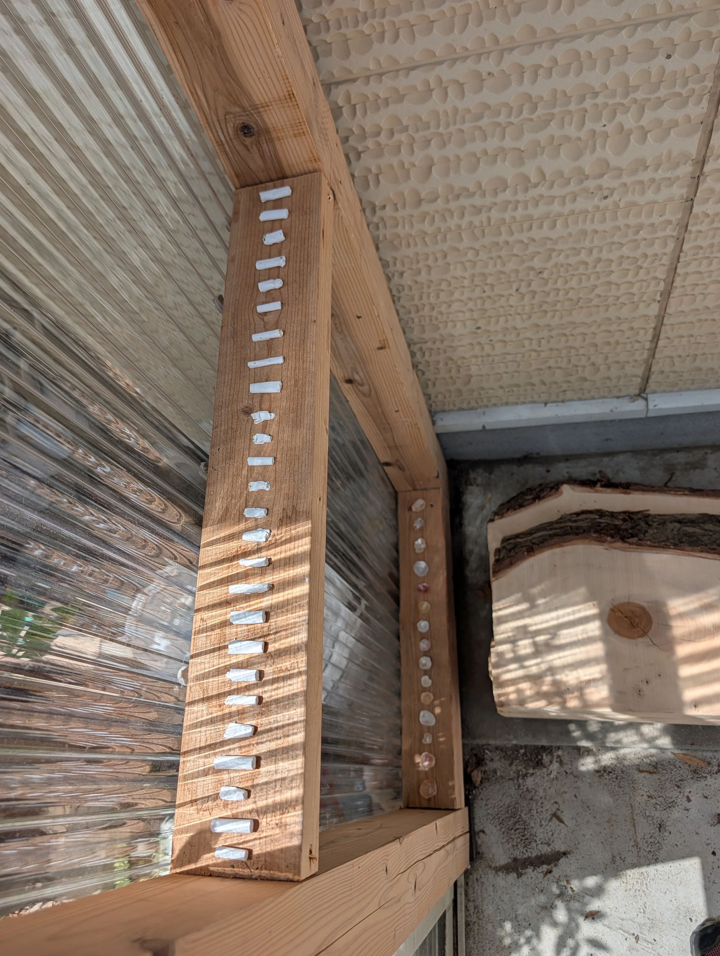 Wooden construction framing with metal roofing and insulation panels.