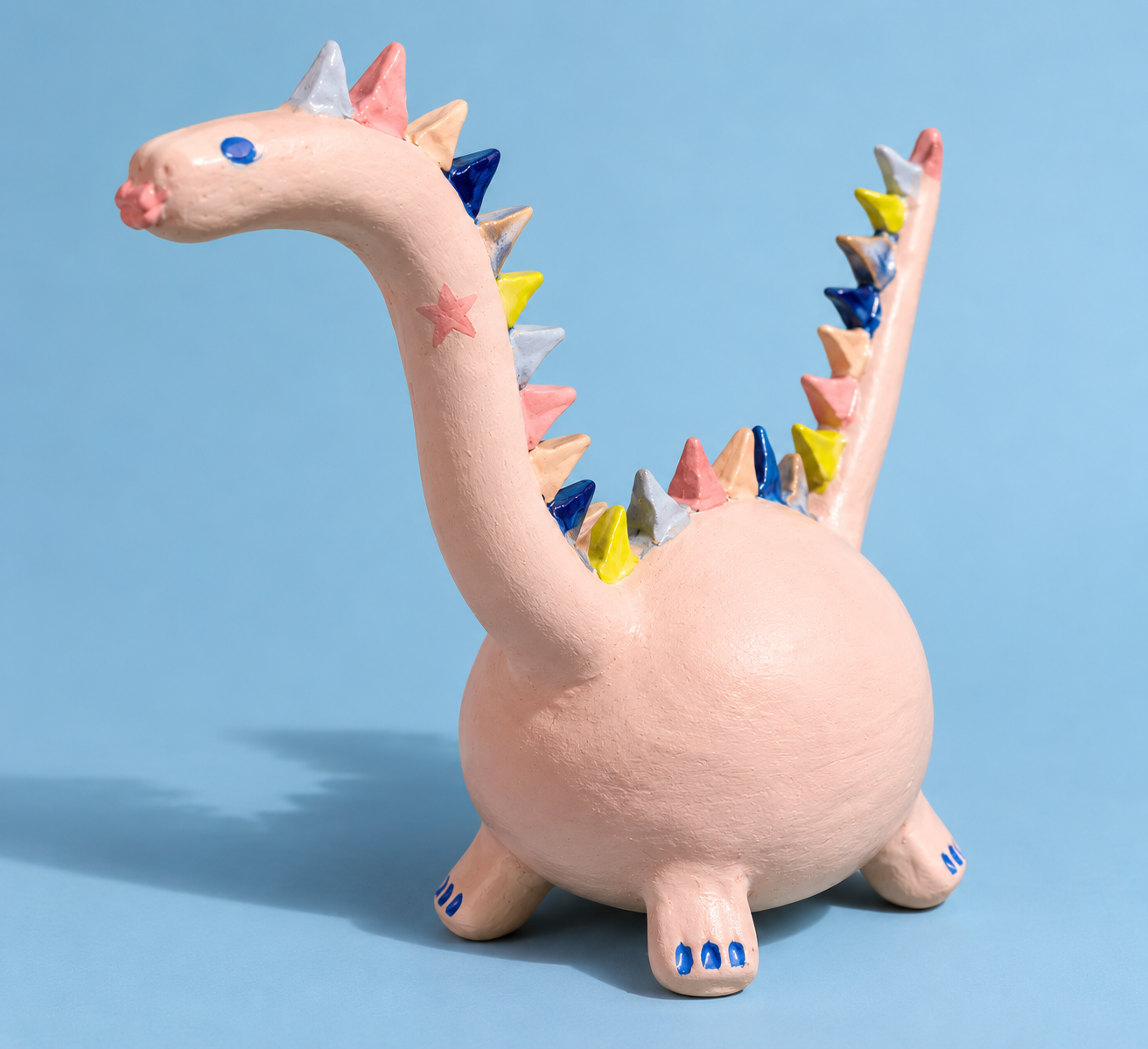 Whimsical Pastel Ceramic Dragon Sculpture.png
