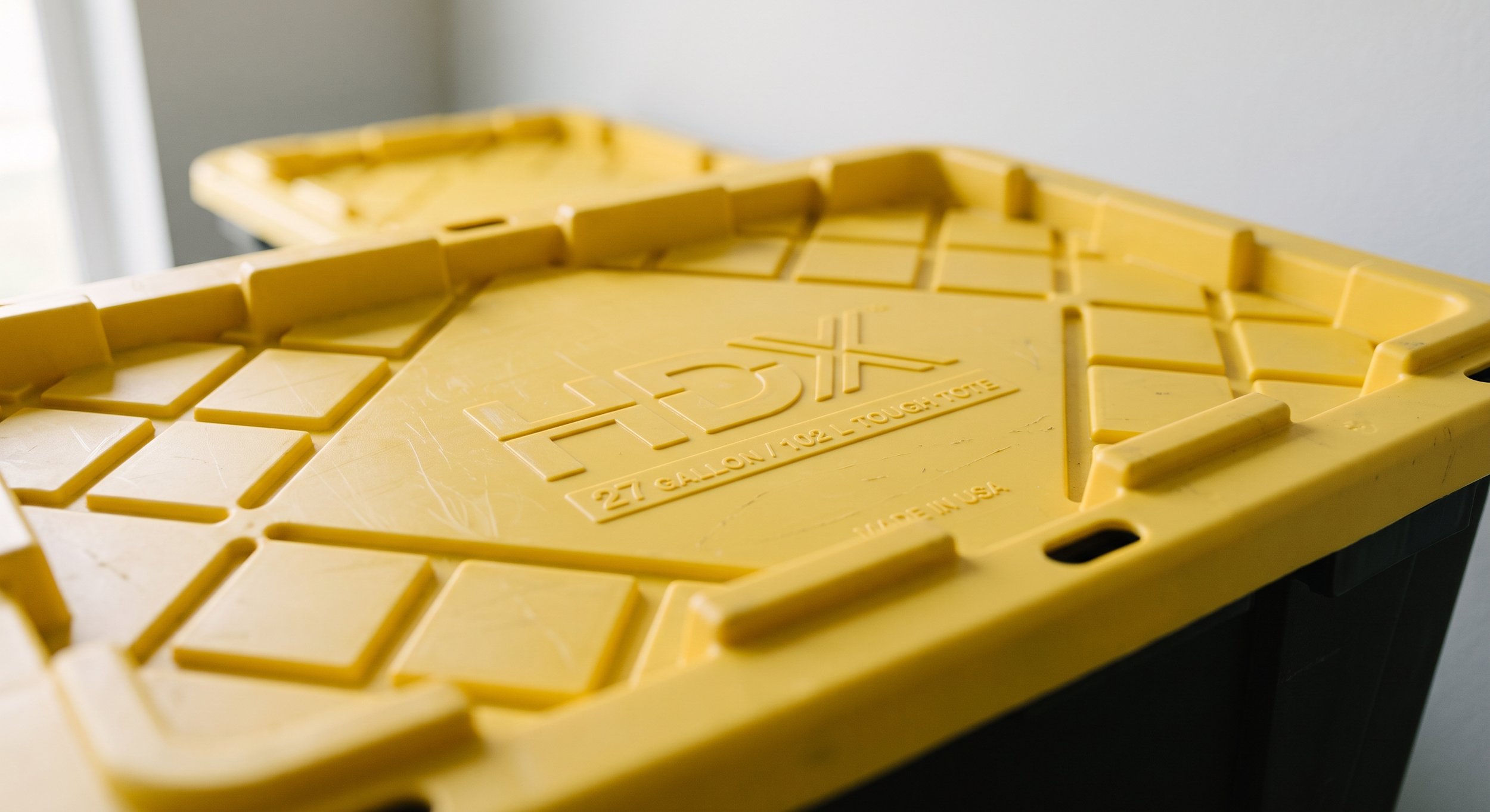 Close-up of a yellow plastic ice rescue sled with the brand name 'Tytex' embossed on it.