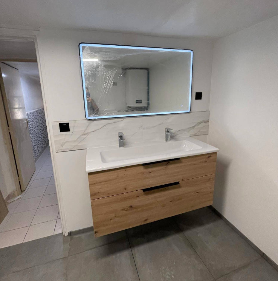 Modern bathroom with a double sink vanity, wooden cabinets, and a large mirror with LED lighting, in a minimalist style.