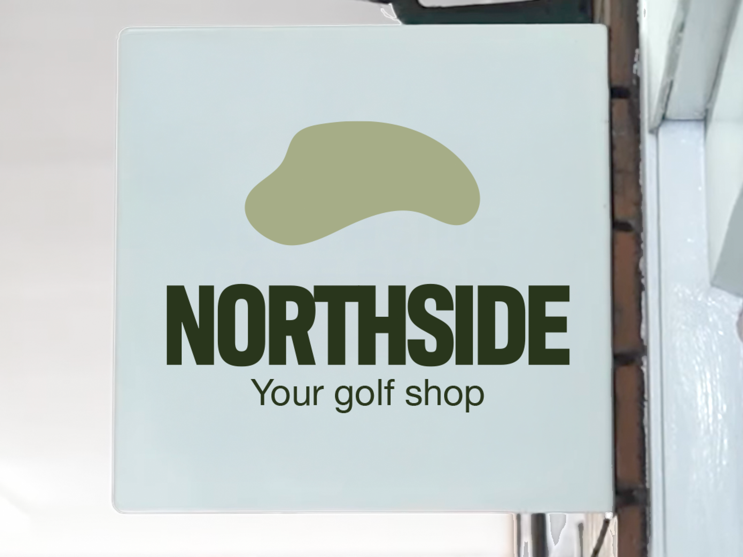 Sign for Northside golf shop with a green logo and black text that reads 'NORTHSIDE Your golf shop'