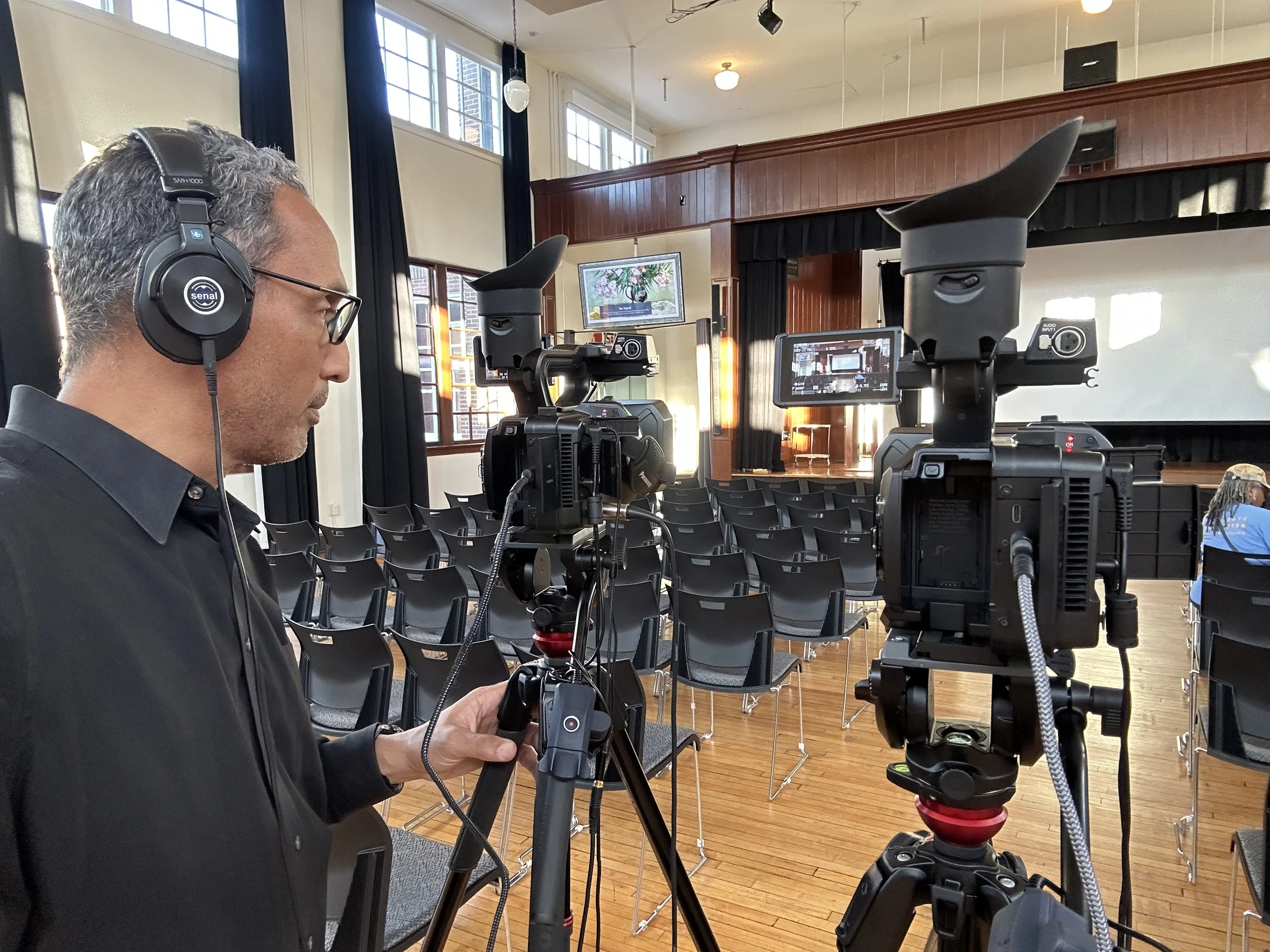 Final checks on the picture quality and audio ahead of the Commission for the Study of the Uprooting of Black Communities in the Commonwealth of Virginia.