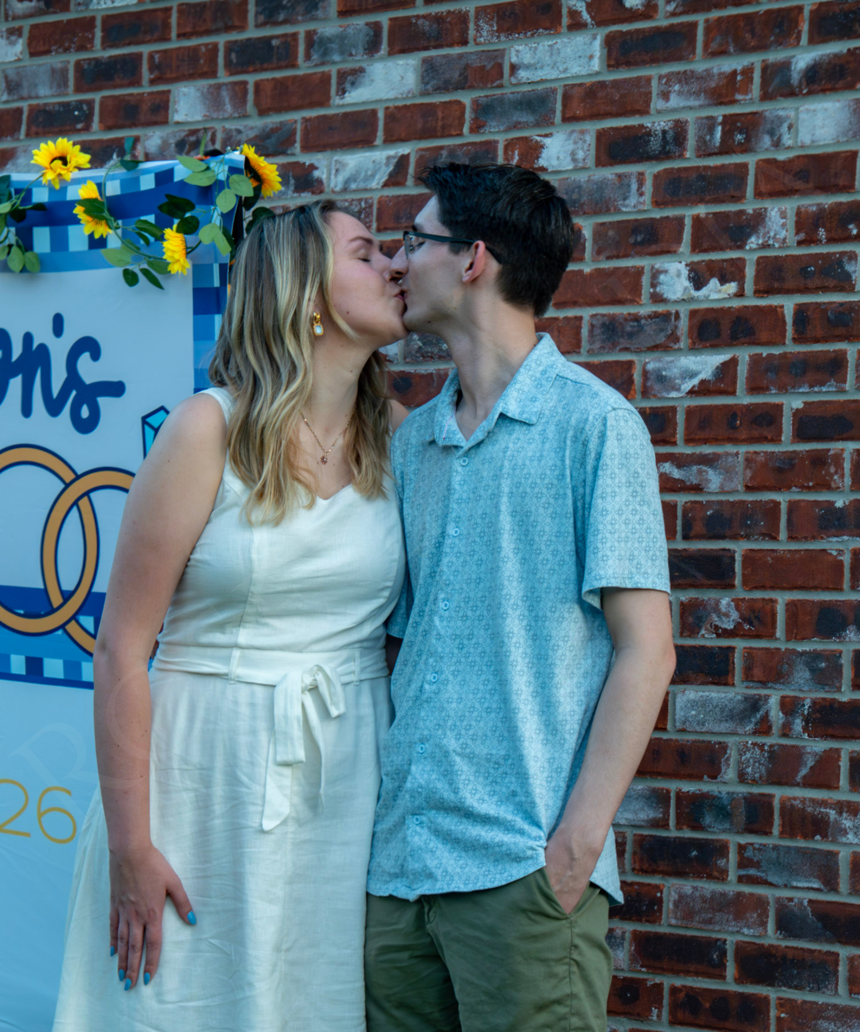 Hanna and Landon celebrate their engagement surrounded by friends and family, captured in a candid moment filled with joy, connection, and the excitement of what’s ahead.