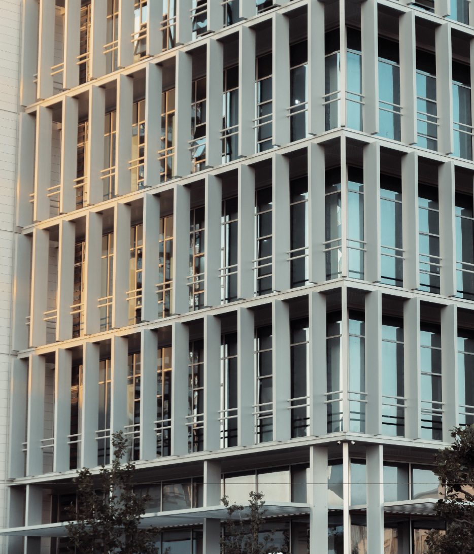 Modern building with glass windows and vertical metal slats.