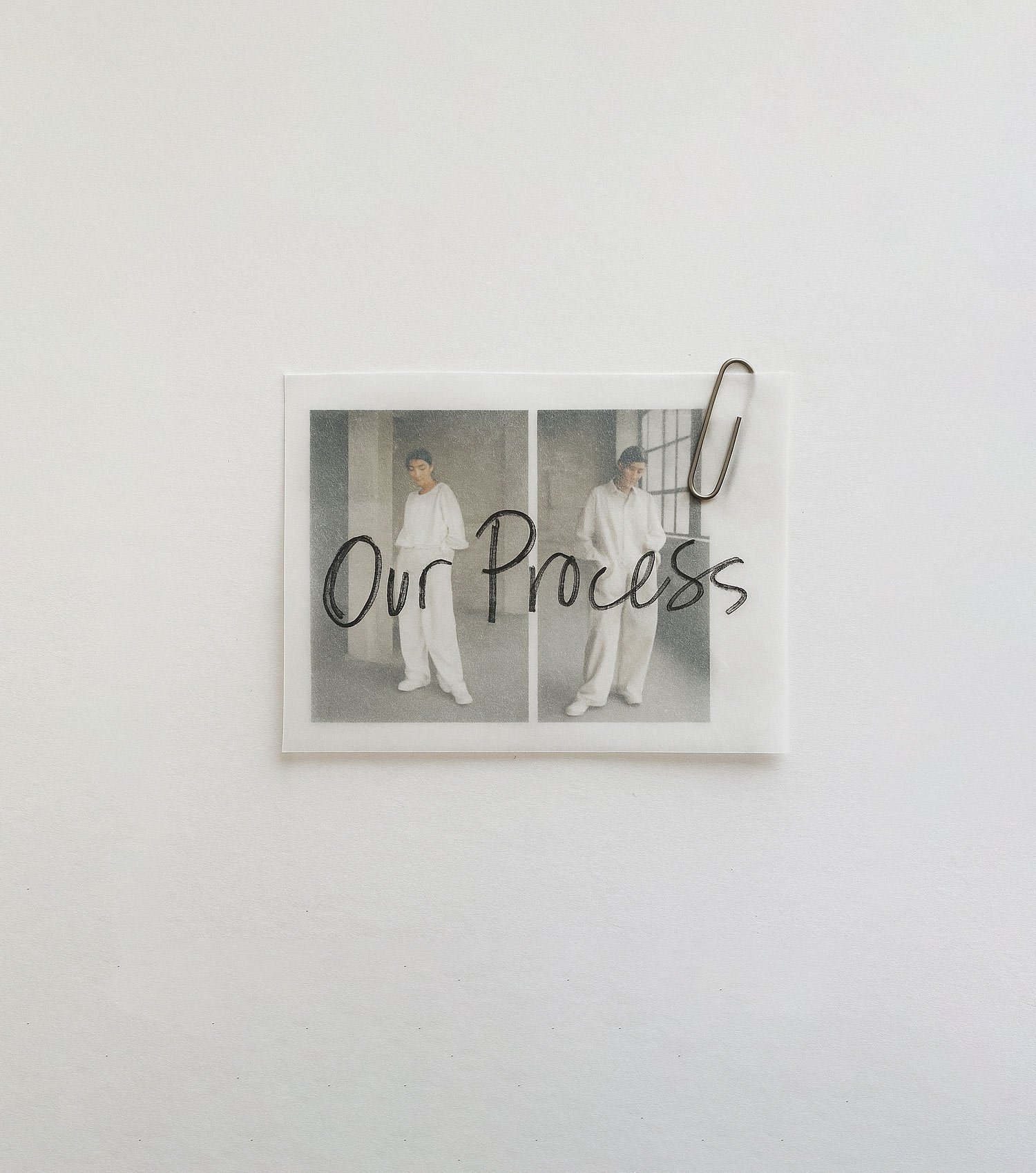 Photograph of two women in white outfits, labeled 'Our Process', attached to a white wall with a paperclip.