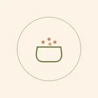 A simple illustration of a bowl with small dots above it, possibly representing bubbles or food items.