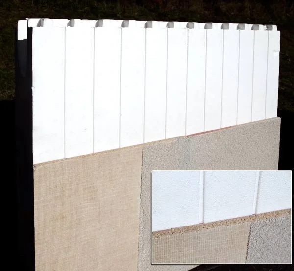 Close-up of a painted wooden fence with a concrete foundation at the bottom.