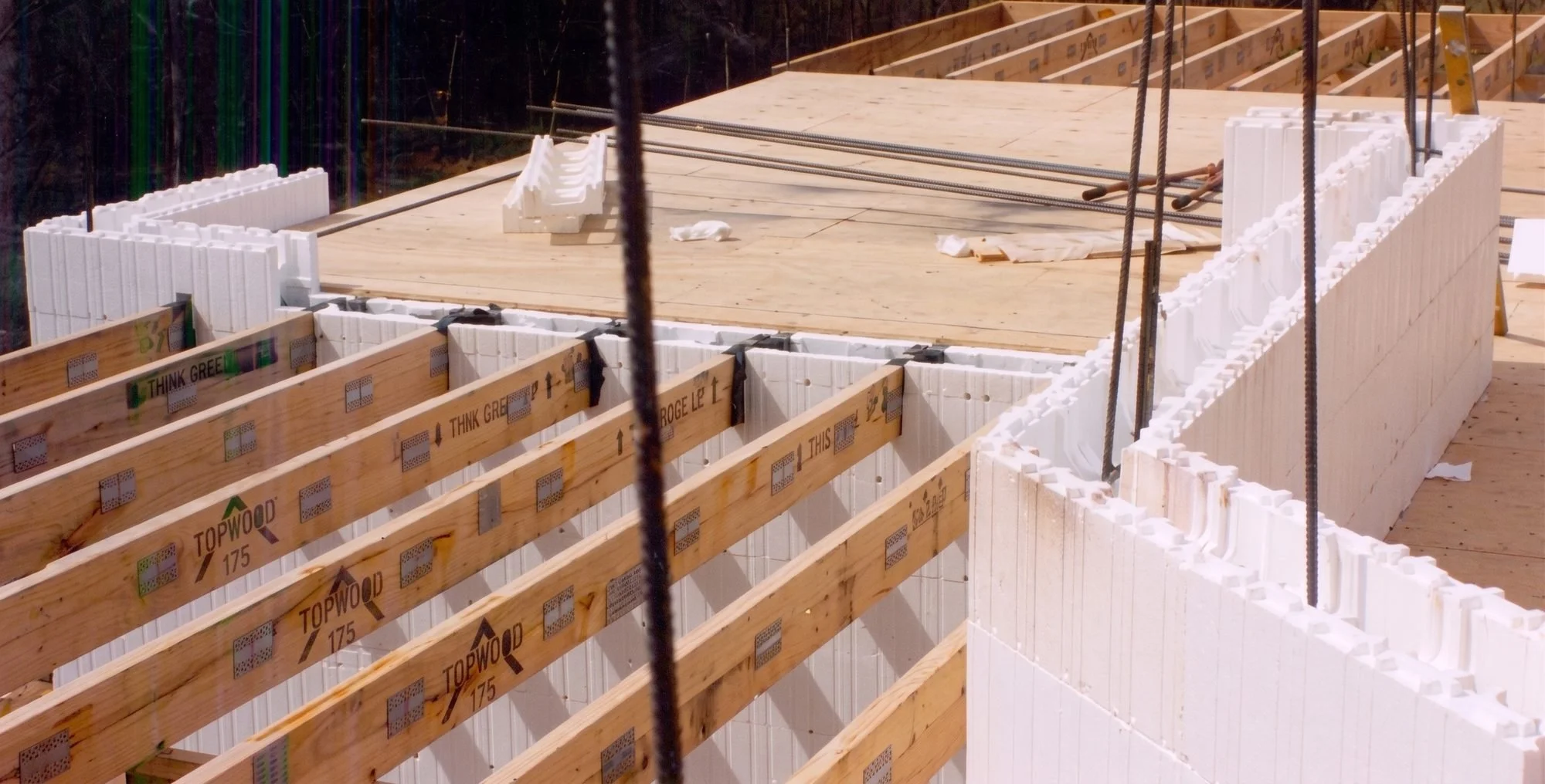 Construction site with wooden framing and insulated foam blocks for building foundation