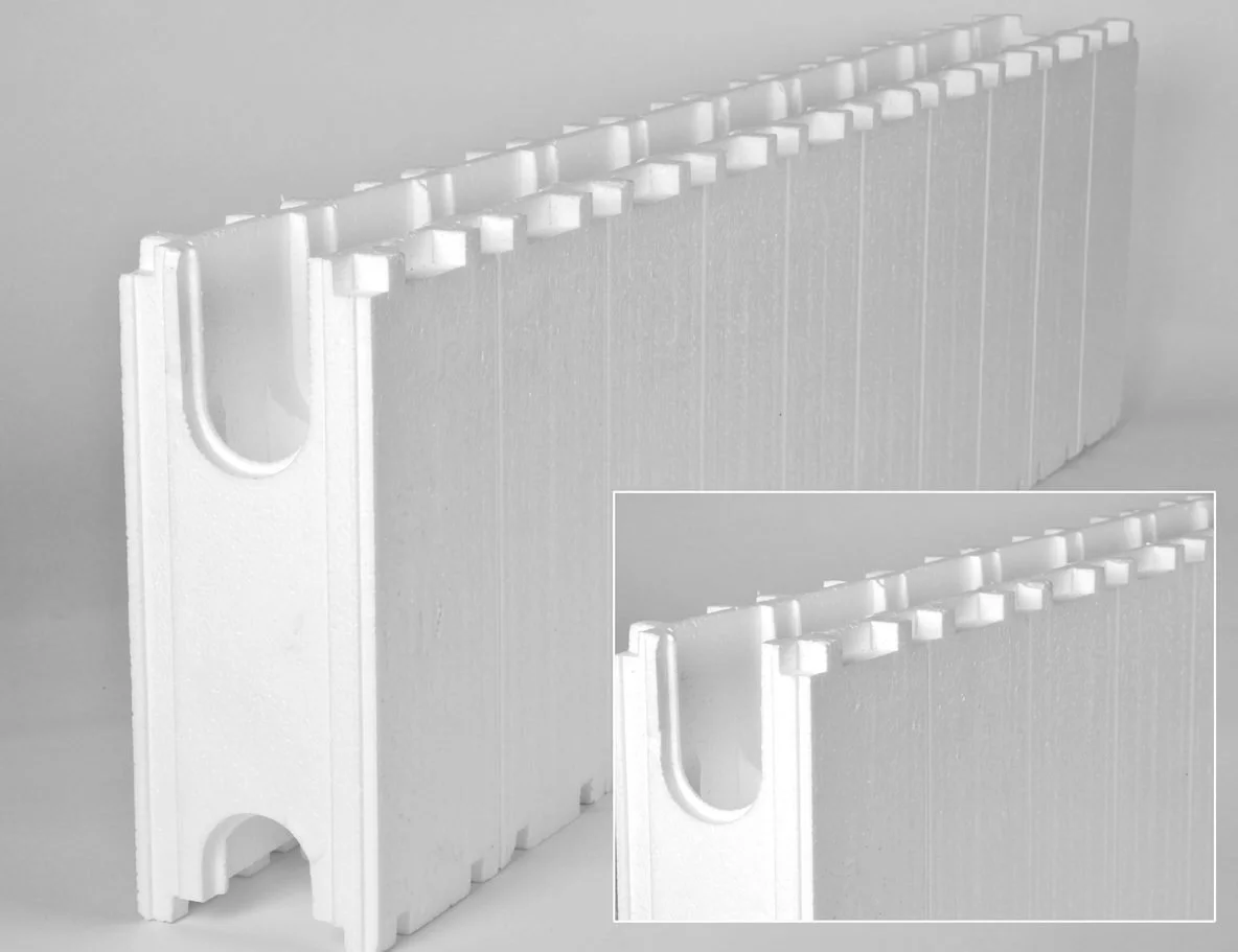 Two white foam corner protectors with a slot and a semi-circular cutout, used for padding and protecting corners in packaging or shipping.