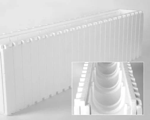 Close-up of a white radiator with a detailed view of the top section and a pipe connection.