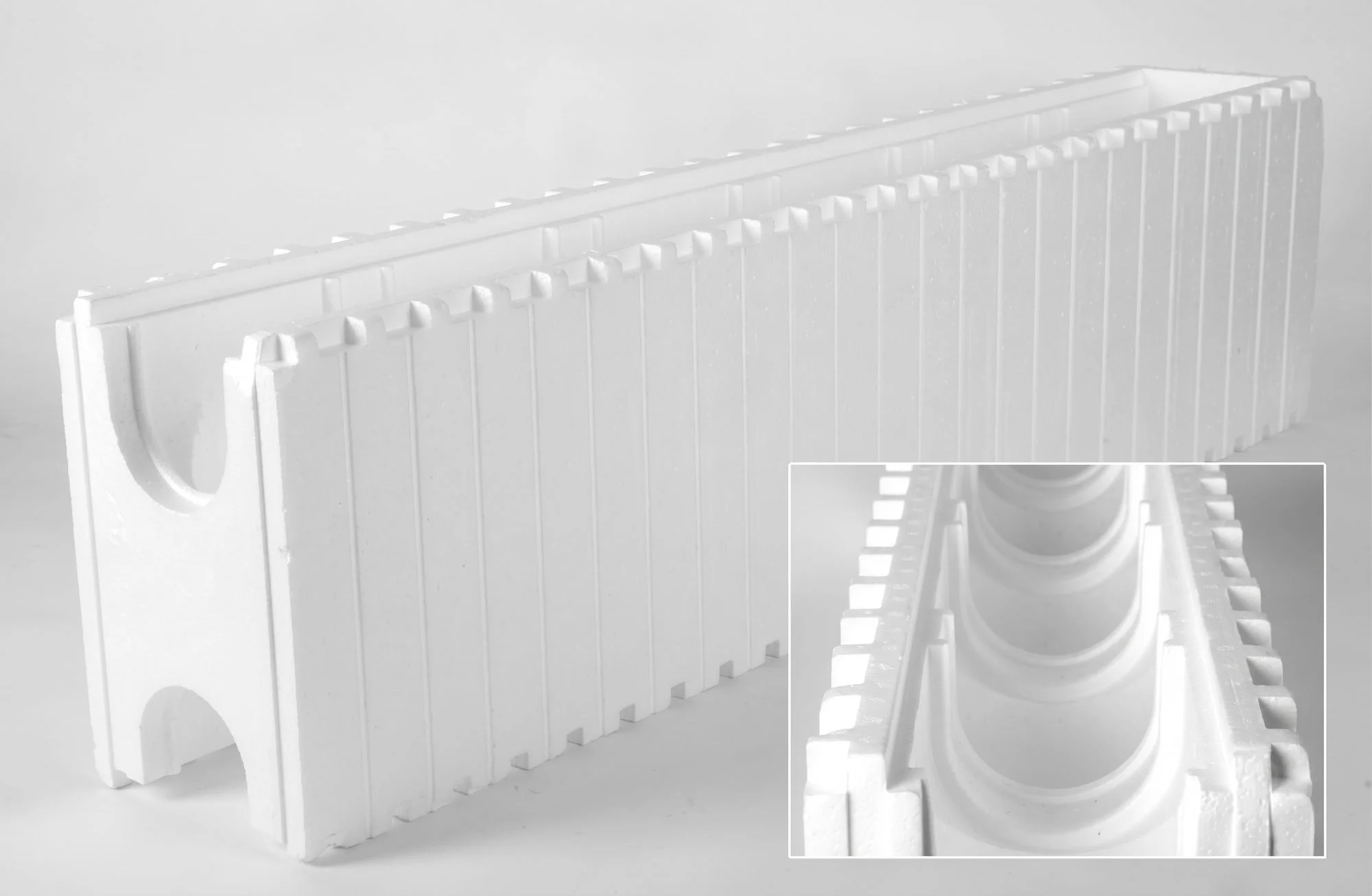 White plastic film reel storage container with a circular cutout and film strips, used to hold and organize film reels.