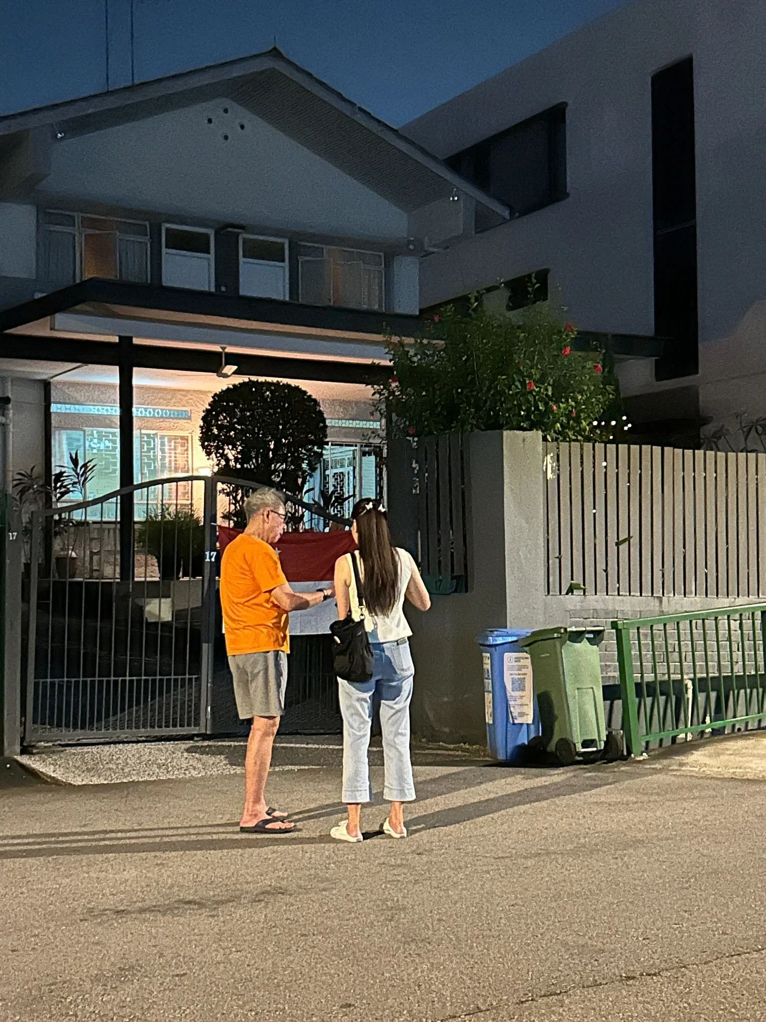 Valerie Ng door-knocking at a landed home in the evening